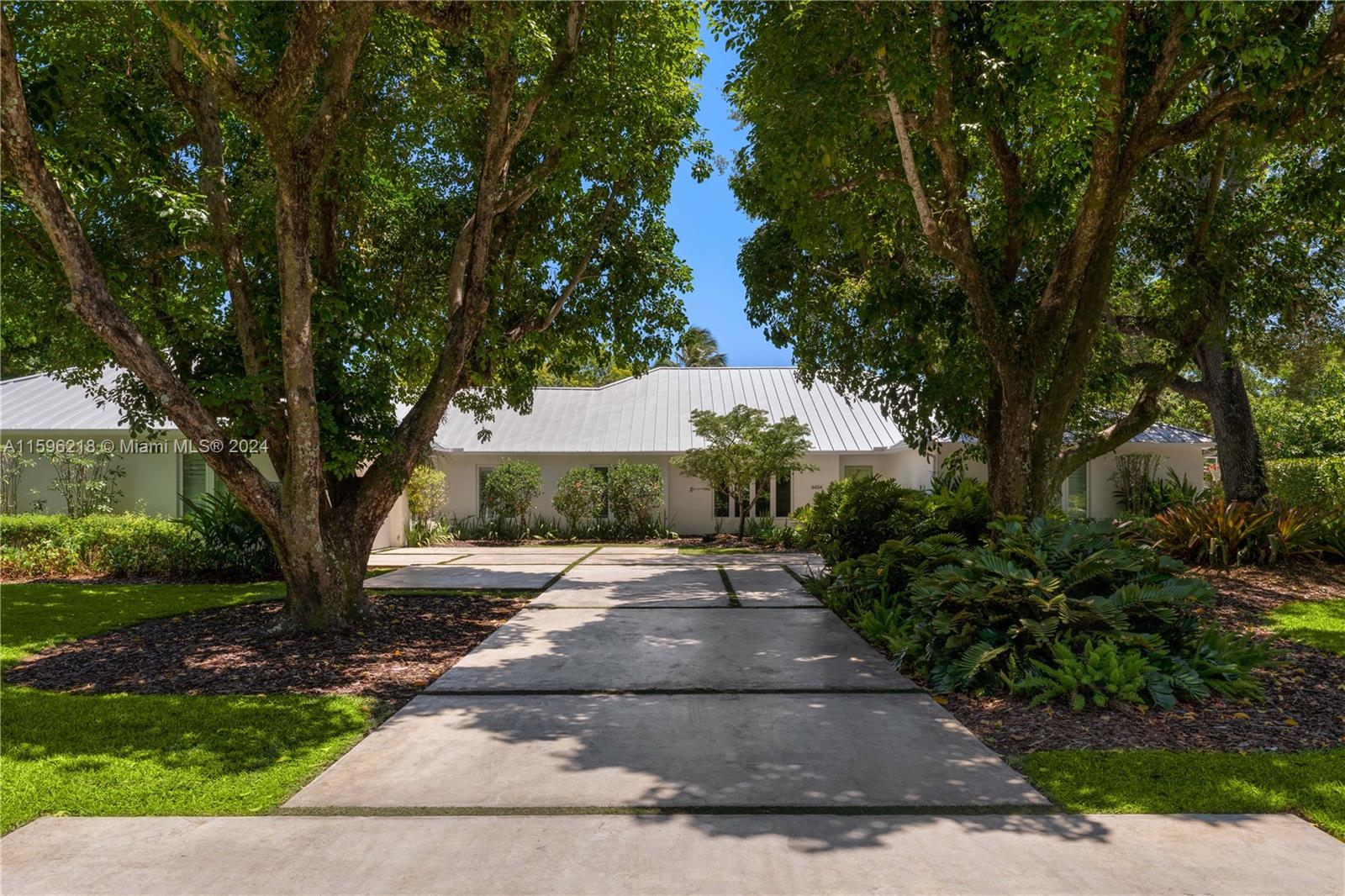 Beautifully renovated 5-bedroom, 4.5-bathroom 6,687 SF home on a spacious lot and quiet tree-lined street in Pinecrest. The residence exudes tremendous curb appeal, and an open layout and vaulted ceilings provide lots of natural light. The impressive eat-in kitchen features custom floor-to-ceiling cabinetry, high-end Wolf and SubZero appliances, gas range, large pantry, and an expansive center island with seating and storage spaces. The interior seamlessly connects to outdoor entertainment areas, a spacious covered patio, barbecue, pool, jacuzzi, and plenty of green space. Additional features include impact windows and doors, whole house generator, gym, two offices, ample parking with two garages, and a metal roof.