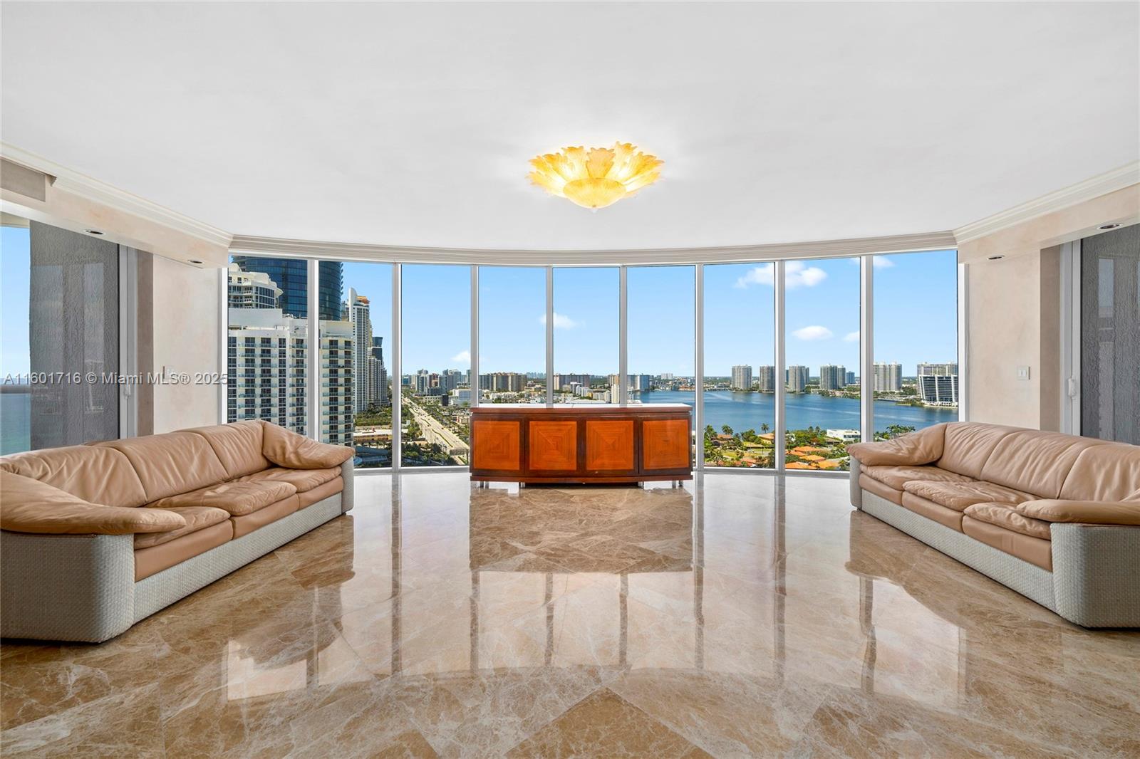 Motivated seller! This magnificent 3 bed. 3 1/2 bath. SE corner residence offers one of the best layouts paired with the most amazing panoramic view in South Florida, overlooking the ocean, bay & the City of Sunny Isles. The unit features three bedrooms in-suite with a powder room accessible by private elevator. Many upgrades, incl. marble flooring throughout, custom made high end built-ins with exotic wood, elegant Murano glass light fixtures, electric screens and more. Property offers lots of amenities including: recently renovated pool deck area w/swimming pool, hot tub, spa, tennis courts, restaurant, community room and roof top deck. Services included: Beach service, 24-hour security, full concierge and valet. Walking distance to shopping, restaurants, K-8 school and house of worship.