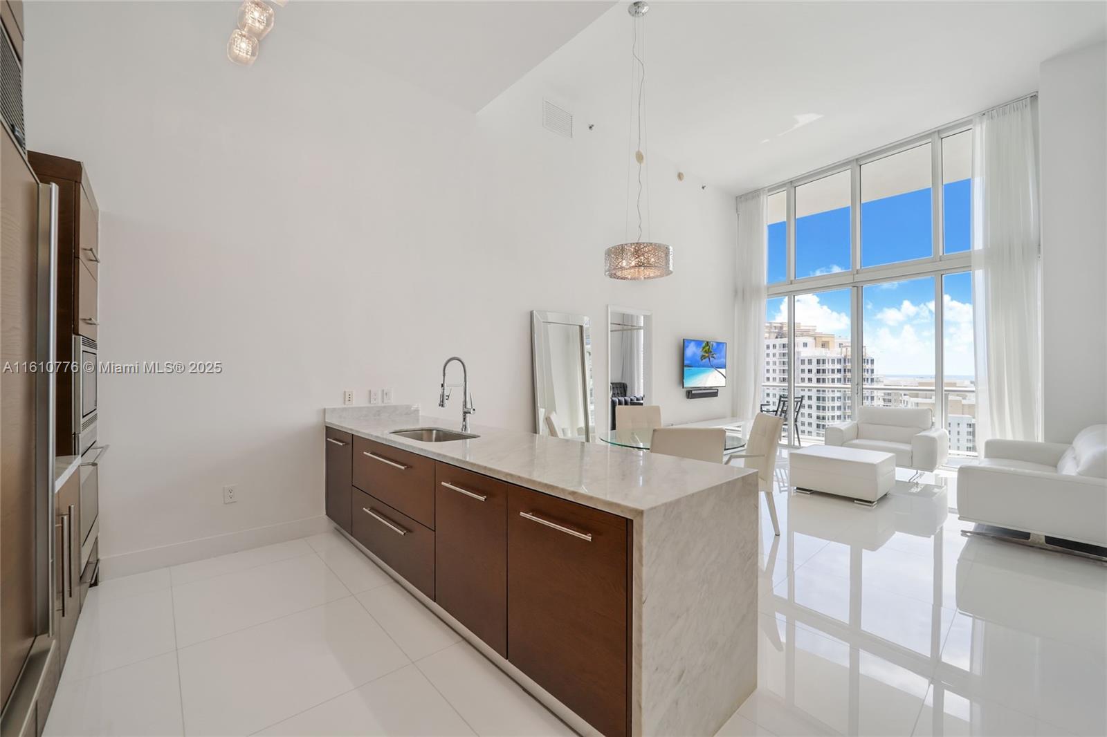 Fully furnished 2-Bedroom + Den, 2-Bathroom unit with 16-foot ceilings in Tower 1 at Icon Brickell featuring a spacious balcony with direct-water views of Biscayne Bay and Brickell Key. 1,461 square feet of interior living space offering double-height ceilings, floor-to-ceiling impact-resistant windows, white glass floors and an open-concept kitchen with Italian cabinetry, stone countertops and SubZero/Wolf/Bosch appliances. Resort-style amenities include full-service spa & fitness center, 300-foot-long pool, swimming pool, hot tub, concierge services and 24- hour valet. Ideally located walking distance from Brickell City Centre and Mary Brickell Village and minutes from Wynwood, Design District & Miami Beach.