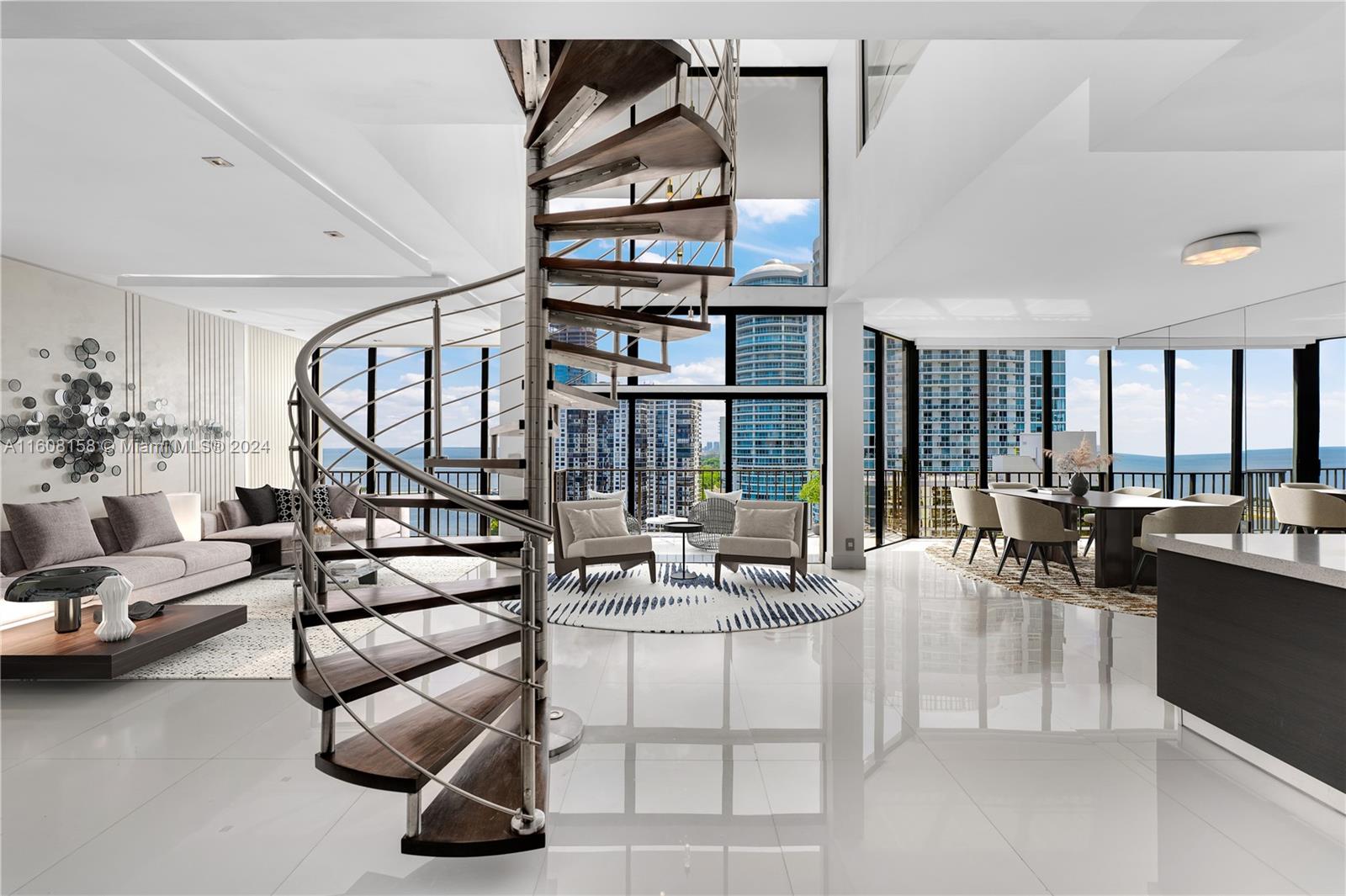 Originally 3 bedrooms converted to 2 bedrooms, which can be reconverted, this stunning TOP Floor 2-story Brickell Penthouse boasts 22' high ceilings and waterfront views. Enjoy panoramic ocean and city vistas, as well as breathtaking sunsets from every room. A striking custom stainless steel and mahogany circular staircase connects both levels, showcasing custom doors and meticulous details. The open island kitchen features top-of-the-line Thermador appliances. The master marble suite offers a Zen tub, double rain shower, and stunning bay views. Residents can indulge in amenities such as a private pool, cabanas, hot tub, children's pool and playground, 6 tennis, racquet, and basketball courts, state-of-the-art gym, party room, private marina, and BBQ area by the water's edge.