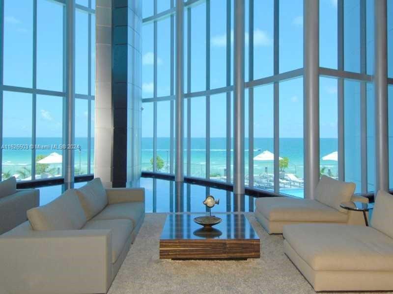 Private elevator leads you to a unique high-end completely remodeled two level Beach front 4BR + maid's quarters/ 5.5BA (4,141SF) penthouse with soaring 22' ceilings. Floor-to-ceiling impact windows throughout open to breathtaking unobstructed 180 degrees of flow through Ocean, City and intracoastal views. All en-suite, large bedrooms & living areas open to 4 amazing terraces. This PH incorporates the highest available in technology allowing full automation of temperature, lighting, blinds and music from your iPad. Downsview Italian kitchen featuring Calacatta marble countertops equipped with Miele appliances and wine cooler. Exquisite wallpaper & real wood floors through out and custom wood paneling in selected areas. ALL NEW RH FURNITURE BROKERS SEE REMARKS FOR AVAILABILITY