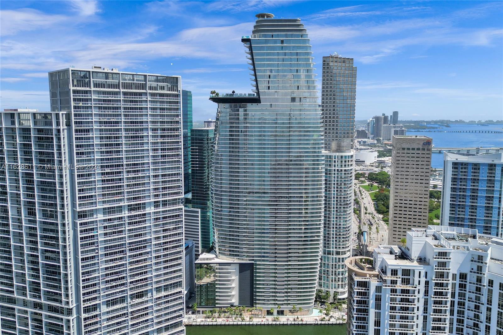 Welcome to Aston Martin Residences Unit 1607! This luxurious 2-bed, 3-bath + den corner unit features a private elevator and private foyer, offering unmatched elegance with white Thassos marble floors, Bulthaup cabinetry, and Gaggenau appliances. Floor-to-ceiling windows provide stunning views of Biscayne Bay, the Miami River, and the Brickell skyline. Enjoy two spacious terraces and a master suite with a walk-in closet, bathtub, and rain shower. Residents benefit from 40,000+ sq. ft. of amenities located on floors 53-55, including a state-of-the-art fitness center, spa, infinity pool, business center, kids' and teens' rooms, two private theaters, and much more. In the heart of the city, you're just steps from top dining, shopping, and nightlife.