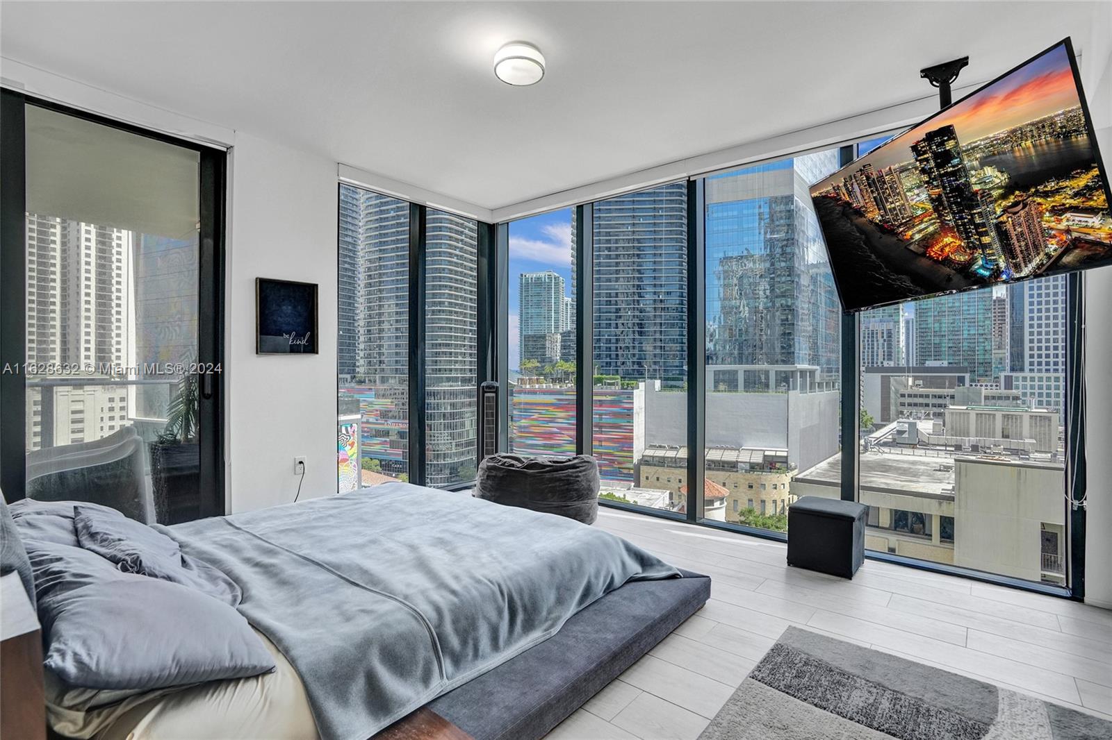 Discover this spectacular upgraded corner unit at the iconic 1010 Brickell Condo. This residence features 1 bed plus enclosed DEN, 1.5 baths, and elegant stone-like porcelain tile flooring. Enjoy the luxury of a glass-enclosed shower, custom-made closets, and 9-foot ceiling heights. The kitchen is equipped with top-of-the-line Smeg appliances. This unit also includes 1 parking space. Enjoy luxury amenities like a rooftop pool, outdoor movie theater, and restaurant. The 12th floor features a co-ed Hammam spa with Jacuzzis, massage rooms, sauna, and steam room. Additional features include basketball and racquetball courts, a running track, indoor pool, fitness center, party room with kitchen, BBQ terrace, and a kids' room with bowling, virtual golf, and ping-pong. Schedule a showing today!