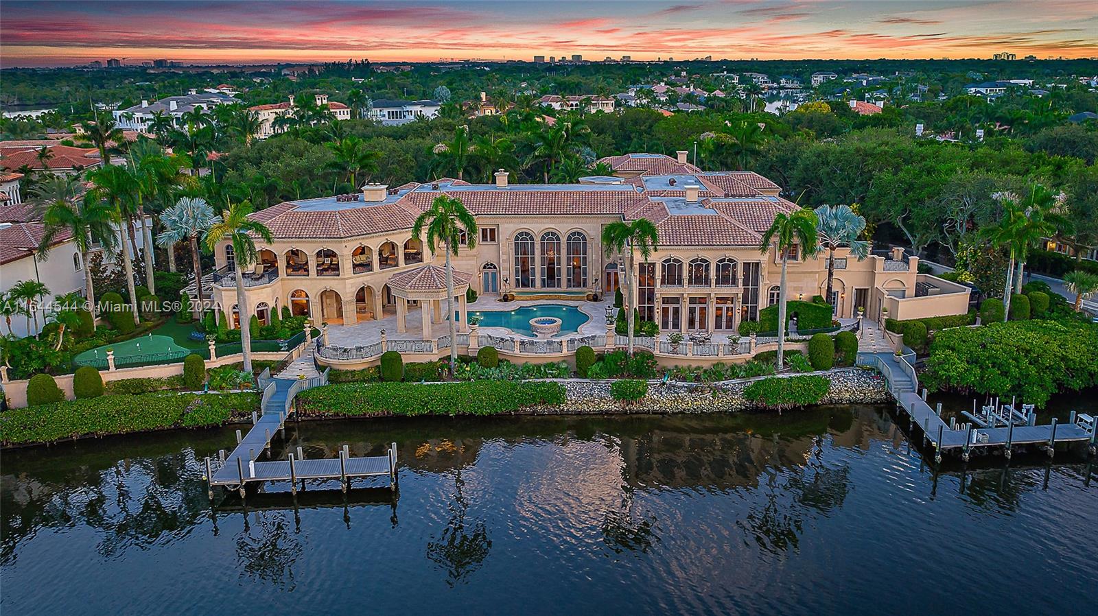 Welcome to this palatial estate in the prestigious Admirals Cove, offering an unparalleled blend of luxury and serenity on the Intracoastal. Boasting an expansive 300 feet of prime waterfrontage, this masterpiece of design and craftsmanship features 9 grand bedrooms and 13 lavish baths, providing ample space for both relaxation and entertainment. The timeless interior exudes sophistication, with each room meticulously crafted to reflect elegance and comfort. The estate includes a separate 3-bedroom guest house, perfect for hosting visitors while ensuring privacy. For car enthusiasts, a 6-car garage offers abundant storage and security. Outdoor living is elevated with two private docks, ideal for accommodating large yachts or multiple watercraft.