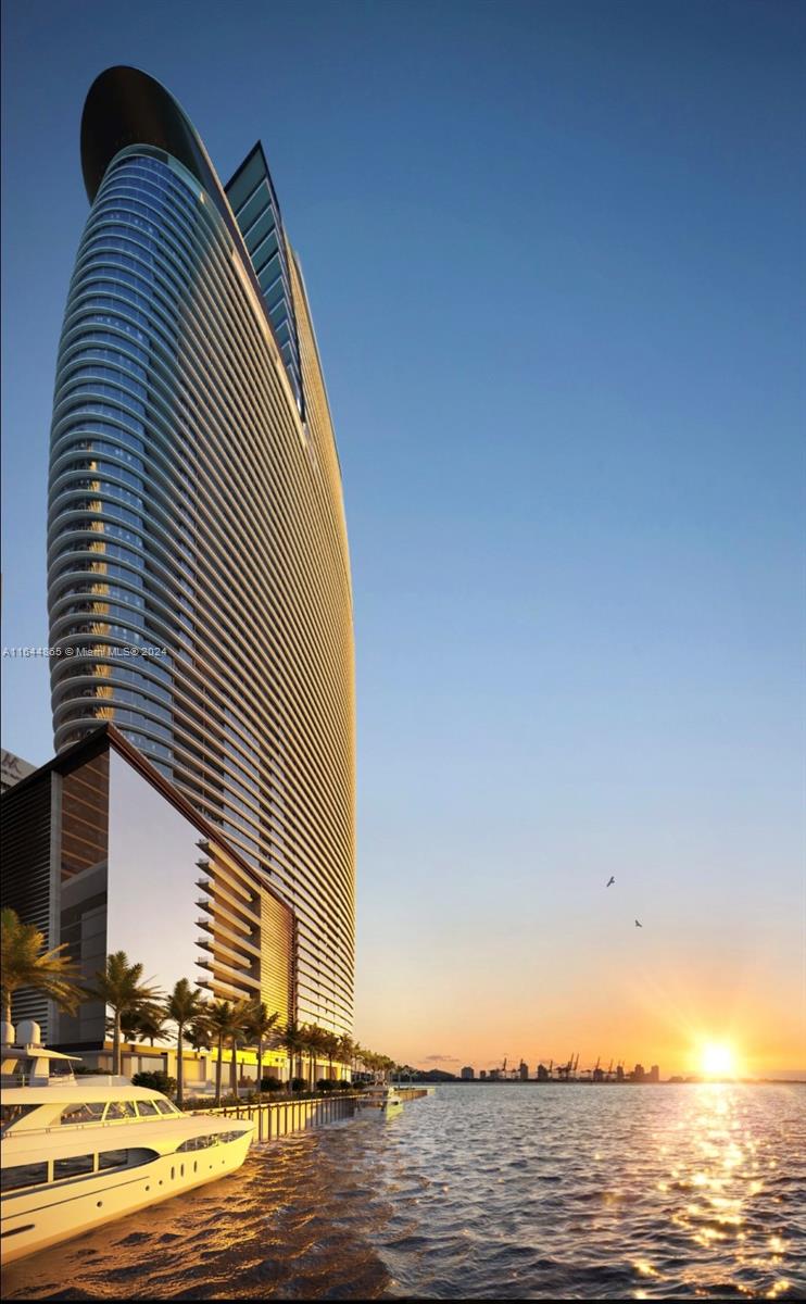 This first Aston Martin Residential Tower, offers their residents a luxurious living experience within this architectural curved glass masterpiece that defines the love for beauty and passion for excellence. The Iconic luxury brand-Inspired Aerodynamics curved shaped glass high-rise, is located at the entrance of Biscayne Bay, and stands tall, and proud, like a modern “Pharos of Alexandria”. The building's materials and finishes were carefully considered and selected by M.Reichman, CCO of Aston Martin, creating a sense of luxury and sophistication unseen before in Miami. Beautiful panoramic views of Biscayne Bay and the Miami River from residence 1102. The building also offers world-class amenities such as entertainment spaces, fitness center, and spa.