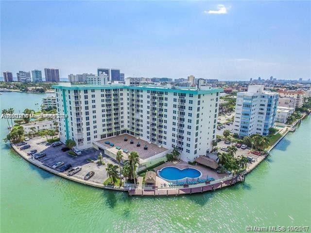 Bright and spacious unit with full Southern Exposure, in the desirable neighborhood of Bay Harbor Islands. Water views from this spacious 1 bedroom and 1 bathroom unit with 950 sq.ft of living space plus balcony. Impact windows and large renovated kitchen. Washer & dryer hookup in unit. Gated building with 24 hrs security, clubhouse, fitness center, marina and oversized pool by the bay with bbq area. Maintenance fee includes the A/C, basic cable, internet, water as well as the common areas maintenance. Close to the beach, restaurants, shops and the A rated K-8 school. Available docks for rent in the condominium.