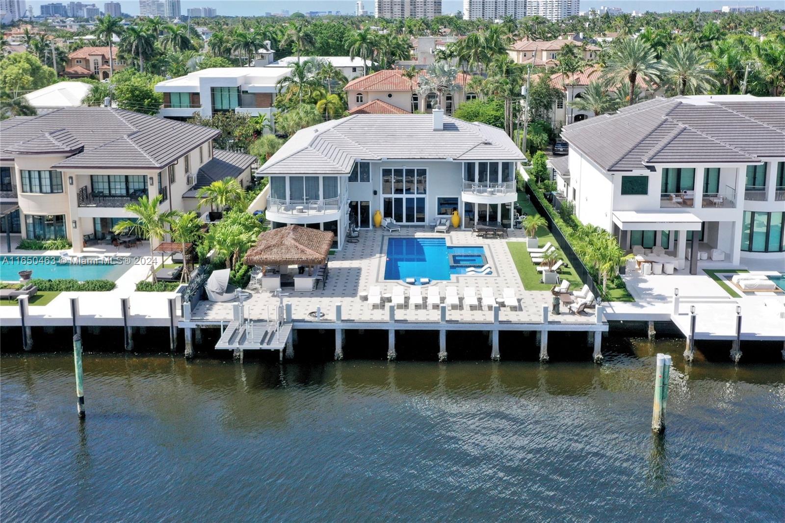 Private Island Allure at this exceptional point lot on the Intercoastal in the gated & security-patrolled Seven Isles. Exclusive turnkey mansion on one of the best streets in South Florida, located just 5 mins from the beach & Downtown Las Olas, offering unmatched luxury in the Yacht Capital of the World. Fully remodeled home boasts wide-open Intracoastal views from every room. Designed for entertaining, the home features a gourmet kitchen, multiple living areas, & a separate primary wing with resort-style baths & dual walk-in closets. Equipped w/ an elevator, backup generator & impact windows, the property ensures convenience & security. Resort-style backyard shows a new outdoor kitchen, ski lift, large pool area, & direct ocean access w/ no fixed bridges. Offered turnkey fully furnished!