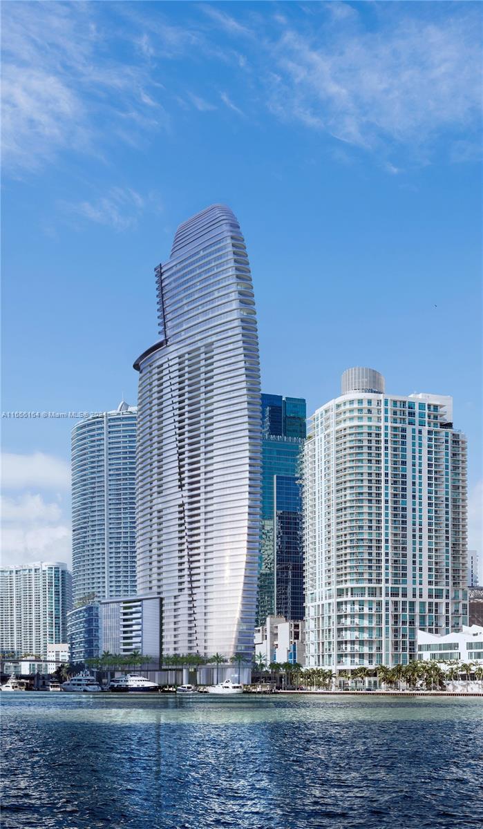 Aston Martin Residences Miami is a luxury residential tower located at 300 Biscayne Boulevard Way. Developed by G and G Business Developments, this 65-story skyscraper features 391 high-end condominiums with designs inspired by the iconic Aston Martin brand. Residences offer expansive layouts, floor-to-ceiling windows, and top-tier finishes. Amenities include a private marina, a state-of-the-art 2 floor wellness center, a sky deck with a pool, and more. The building’s sleek, modern design and prime waterfront location make it a prestigious address in Miami’s vibrant downtown area.