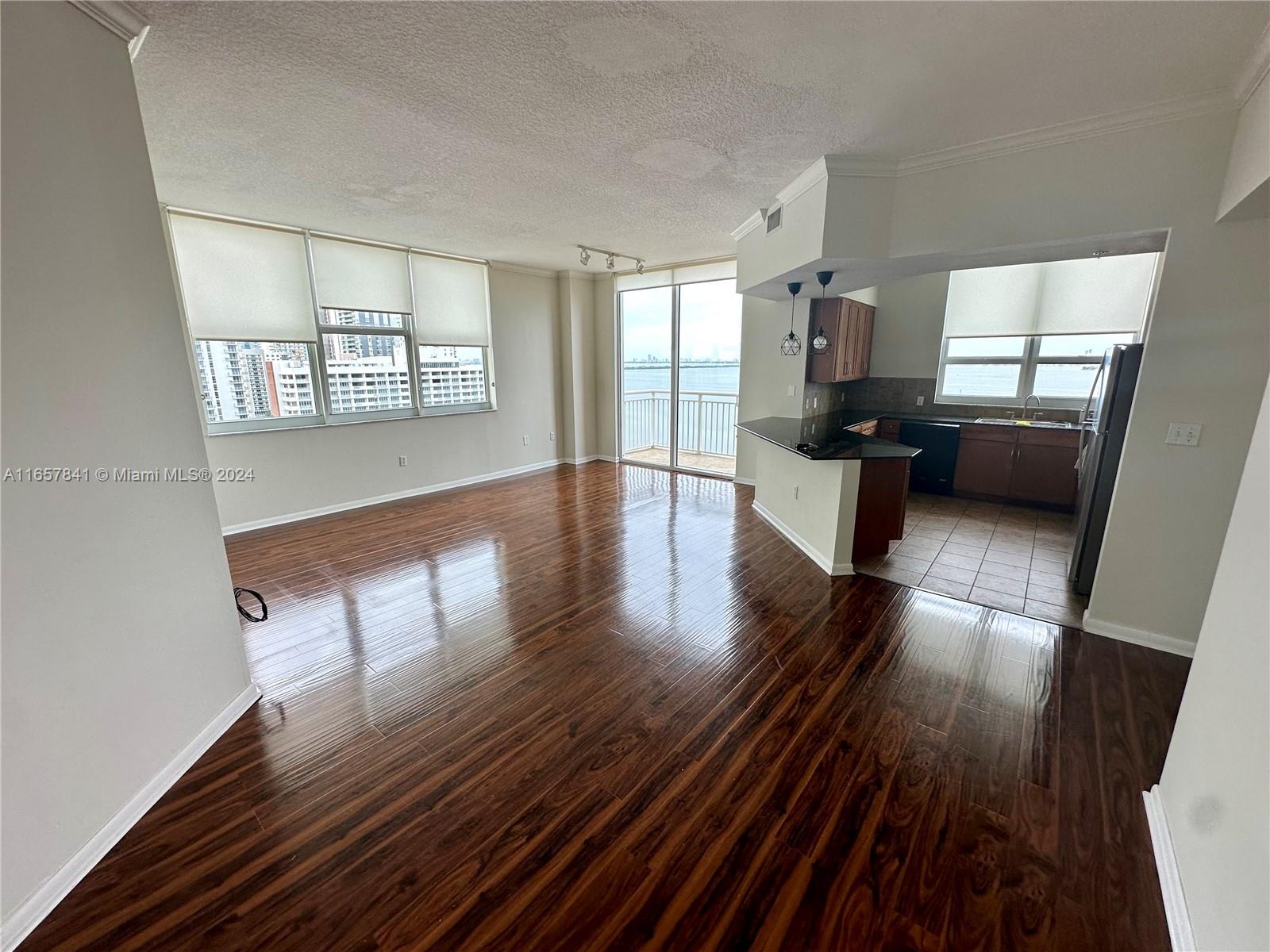 Spacious 3 BED / 2 BATH condo with water views from every room. Features laminate floors, open kitchen with granite countertops, full-size washer/dryer, and 2 balconies. Includes 2 assigned parking spaces. Building offers 24/7 concierge, valet, security, business lounge, gym, heated pool, and social room. Prime location across from Margaret Pace Park with basketball, volleyball, tennis courts, and a dog park. Close to restaurants, Arsht Center, Wynwood, Midtown, Design District, and the beach.