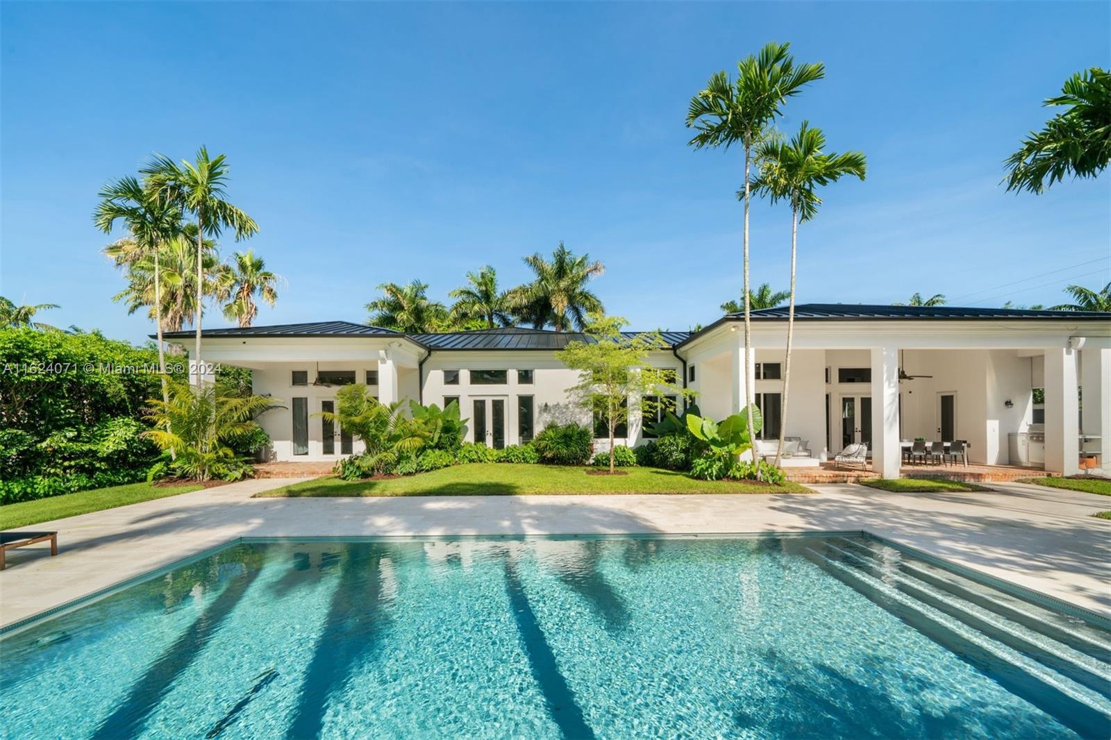 In the heart of East Pinecrest on a private rd in the gated Sanctuary enclave, this 5BD 5.2BA spectacularly redesigned 1-story sits on a professionally landscaped .87 acre. Sophisticated floor plan showcases wide open liv areas, 13-14’ volume ceilings, gourmet kitchen, walk in pantry, wine storage, wide plank wood floors & spacious laundry rm. Luxury primary suite w/office, lavish bath, 2 walk-ins. Chicago brick driveway w/ample parking & 2-car gar w/storage. Relaxing veranda & bbq overlooks new htd saline pool & cool deck, convenient cabana BA. Kids claim their turf w/ backyard soccer field & playground! All impact glass, new metal roof & full house generator. Sidewalk access to Pinecrest Grdns & Comm Cntr, Farmers Mkt. Top schools, bicycle to Red Rd, parks, tennis, Wayside Market & SoMi.