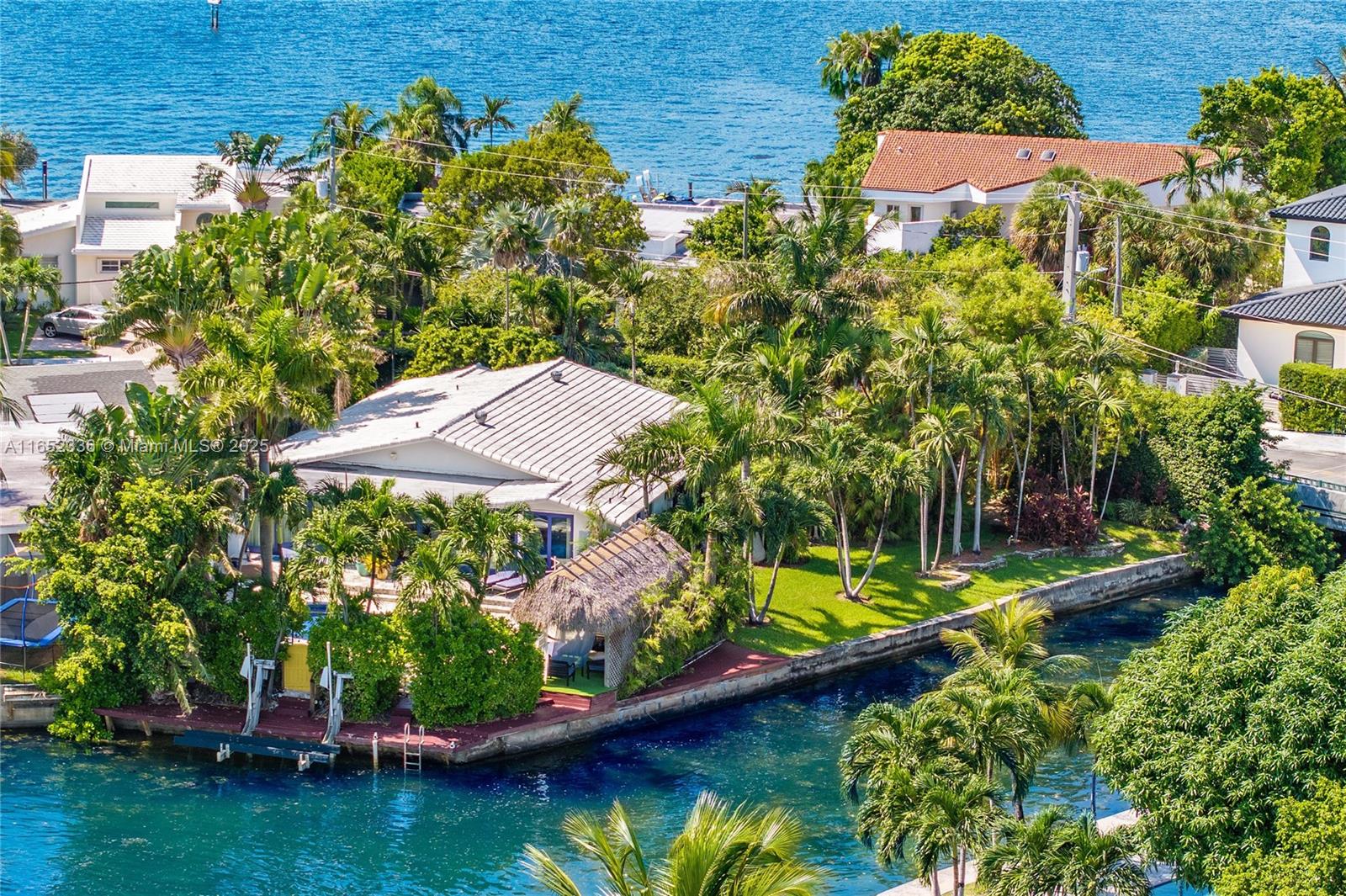 Rare opportunity to own corner, gated waterfront property on Miami Beach’s exclusive Biscayne Point. Home is situated on the Point’s circle w/ oversized 12,350 SqFt lot & 168 ft of waterfront surrounded by lush landscaping for utmost privacy. Live the ultimate Miami Beach waterfront lifestyle w/ dock, boat lift (10k lbs), jet ski/kayak platform & heated pool, perfect for water sports & activities. Backyard includes large tiki hut, wet bar, Argentinian grill, covered outdoor area, & sun lounges. Leave your cars behind & explore Miami’s waterfront venues by boat. Minutes from Bal Harbour Shops, Lincoln Road & quick walk to the ocean. Design and Build your dream luxury home, Sabal Luxury Builder and Togu Design offer an exceptional partnership in high-end residential construction and design.