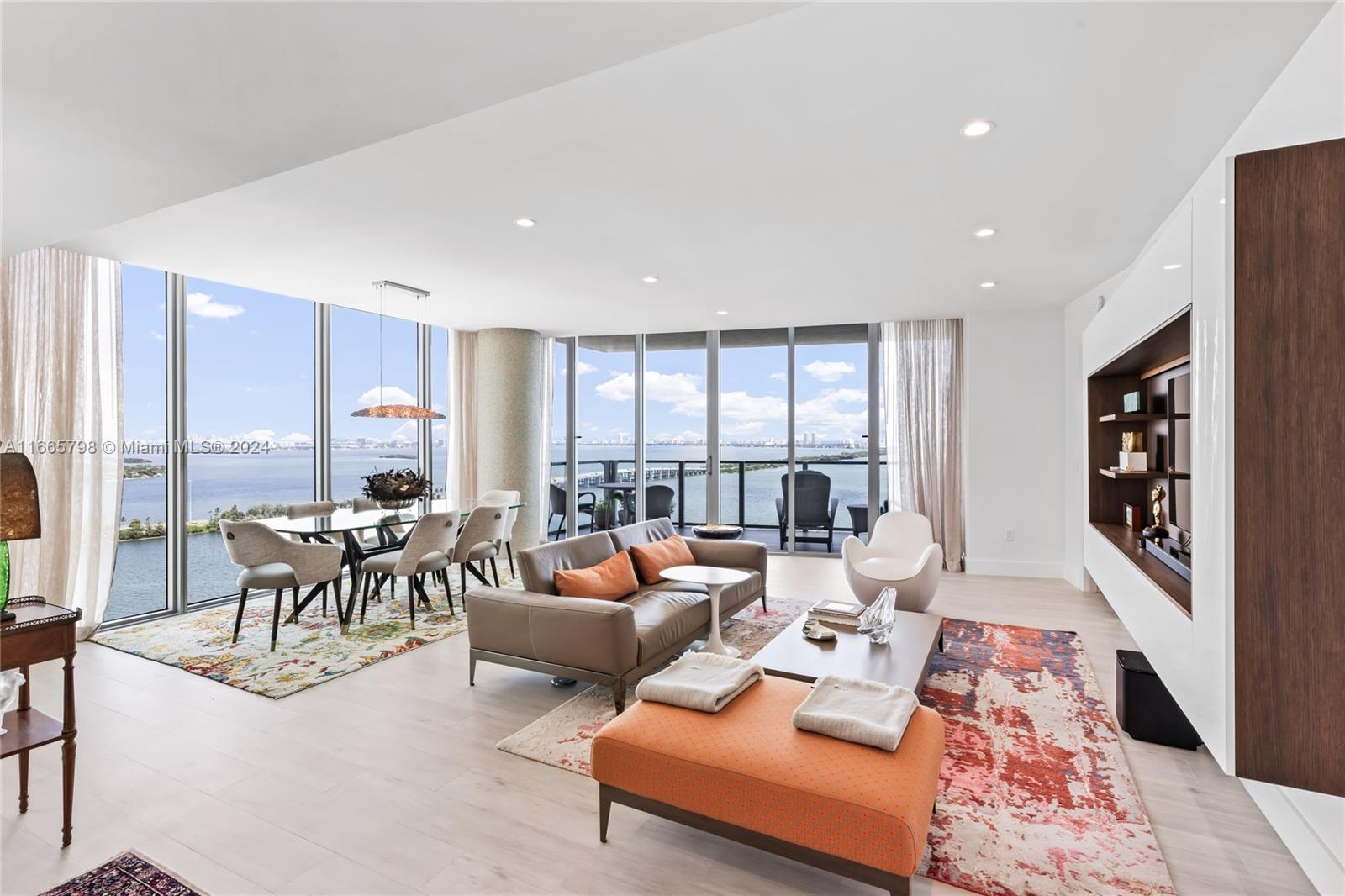 Enjoy breathtaking views of Biscayne Bay, and Miami Beach from this spectacular corner unit. Access your home through a private elevator into a thoughtfully converted spacious 2 beds plus a den (potential 3rd bed) and 3 baths. With 10+ ft floor-to-ceiling windows and two balconies, natural light fills the space. The open kitchen features a large island, top-tier Miele appliances, and custom European cabinets. The luxurious primary bath includes a spa tub, separate shower, dual vanity, and walk-in closet. The building offers resort-style amenities, including a Beach Club, two pools, tennis courts, a fitness center, theater, salon, sauna, steam room, business center, billiards room, and valet parking. Comes with 2 parking spaces & a storage unit.