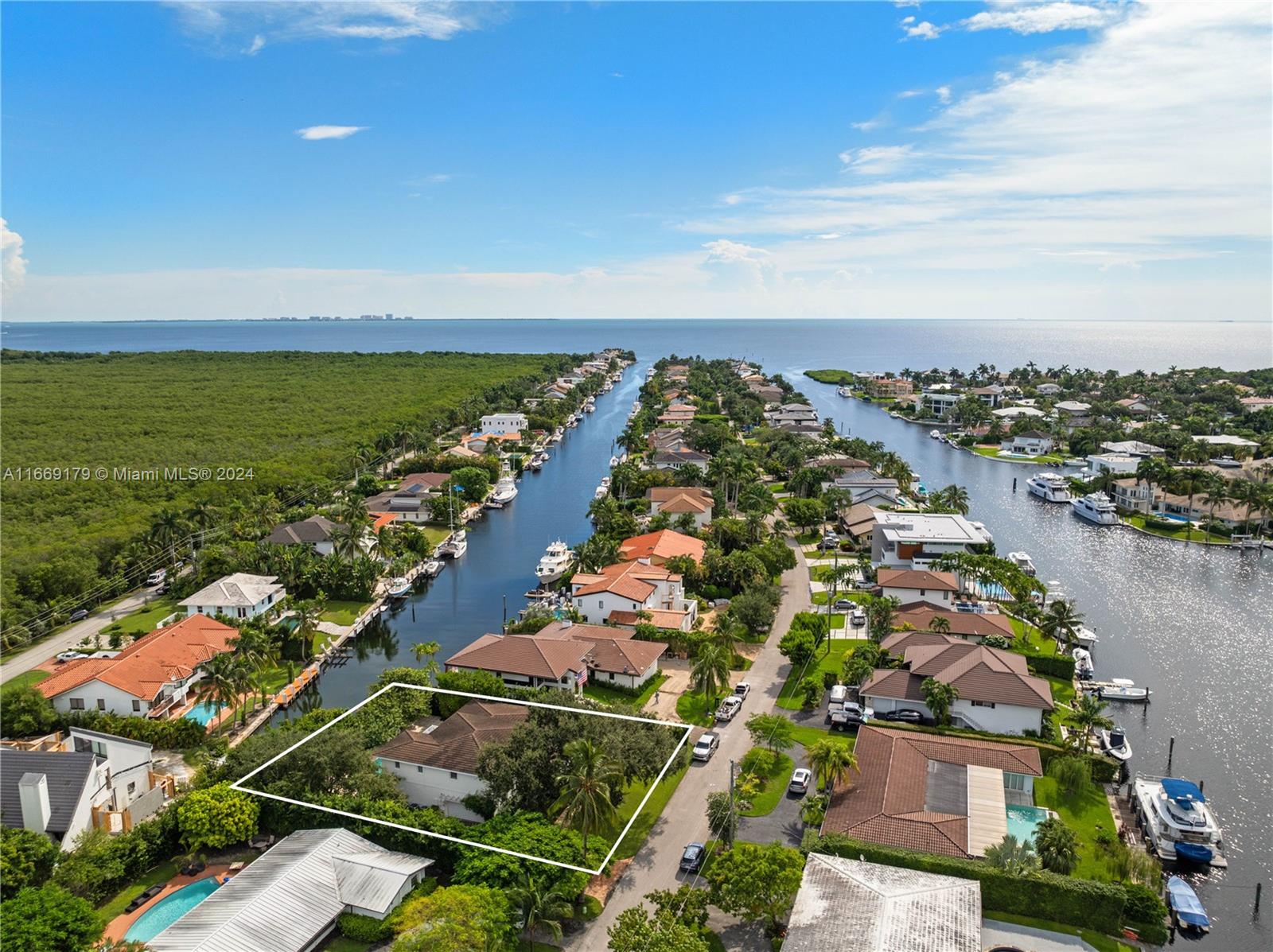 Stunning 4,467 SF two-story canal-front home with 4BD/4.5BA and direct ocean access, located on a 12,366 SF lot in the guard-gated community of Gables by The Sea. This thoughtfully designed home offers an open floor plan, soaring ceilings, 3 en suite bedrooms upstairs, and an eat-in kitchen with a large island, gas range, marble countertops, and high-end appliances. Outdoor features include a saltwater pool with jacuzzi and tanning ledge, covered terrace, pergola, and private dock. Additional highlights: Chicago brick driveway, 2-car garage, impact windows/doors, custom wet bar, and glass wine cellar.