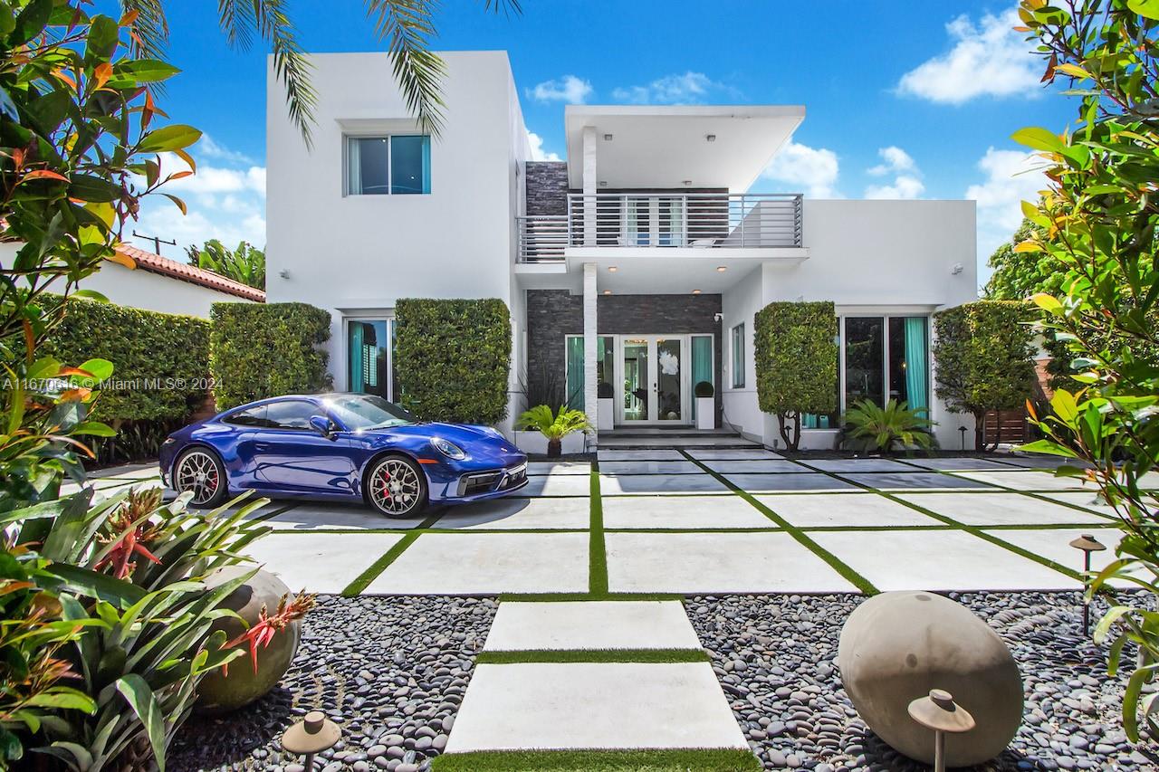 Contemporary home in Miami Beach surrounded by lush tropical landscape and situated in front of the Golf Club. The home was renovated into a masterpiece in 2016. This 2-story home is gated with an elegant entry and offers an expansive open modern floor plan perfect for entertainment. The energy efficient smart home features 4 bedrooms, a bonus room that can be converted into a bedroom, and 4.5 bathrooms. Master suite is conveniently located downstairs. Open family-friendly kitchen leads into TV family lounge and dining room, featuring Miele appliances and quartz waterfall counters. Large outdoor space with private heated pool, summer kitchen, and cabana. Enjoy the Miami Beach lifestyle in this family-friendly neighborhood within walking distance to Lincoln Road and other top attractions!