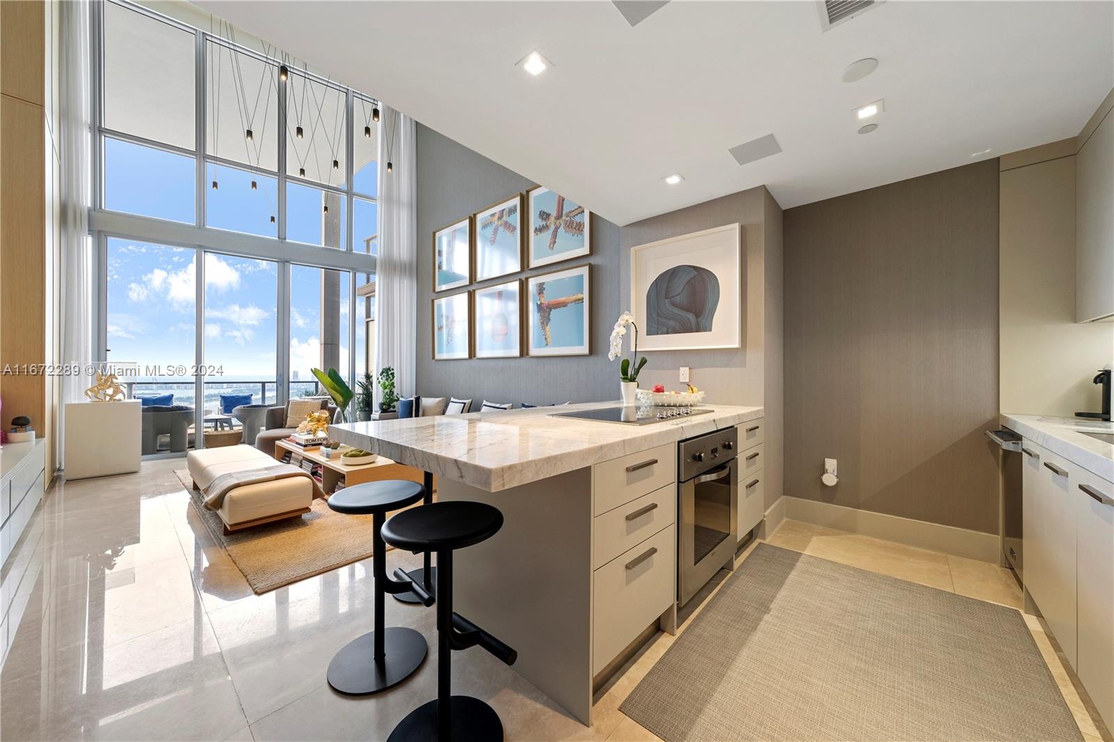 This exquisite 49th floor, 2-story loft home has been designer finished + furnished. Enter the home, pass the den that serves as an office/guest room, down the hall + by the laundry room + full bathroom, grab a drink from the stunning eat-in-kitchen + be WOWED by dramatic views of Biscayne Bay through the 20-foot floor-to-ceiling-windows. The 2nd floor is dedicated to the spacious + bright Primary Bedroom Suite with a large walk-in closet + spa-like bathroom. Located within "the light box" at the Marquis, this residence features a double-depth balcony overlooking Museum Park, Biscayne Bay + the Miami Skyline. Dine + shop at Miami World Center, take in a show at the Arsht Center, go for a jog across the Venetian Causeway, or a quick drive to the beach to enjoy exclusive beach club services!