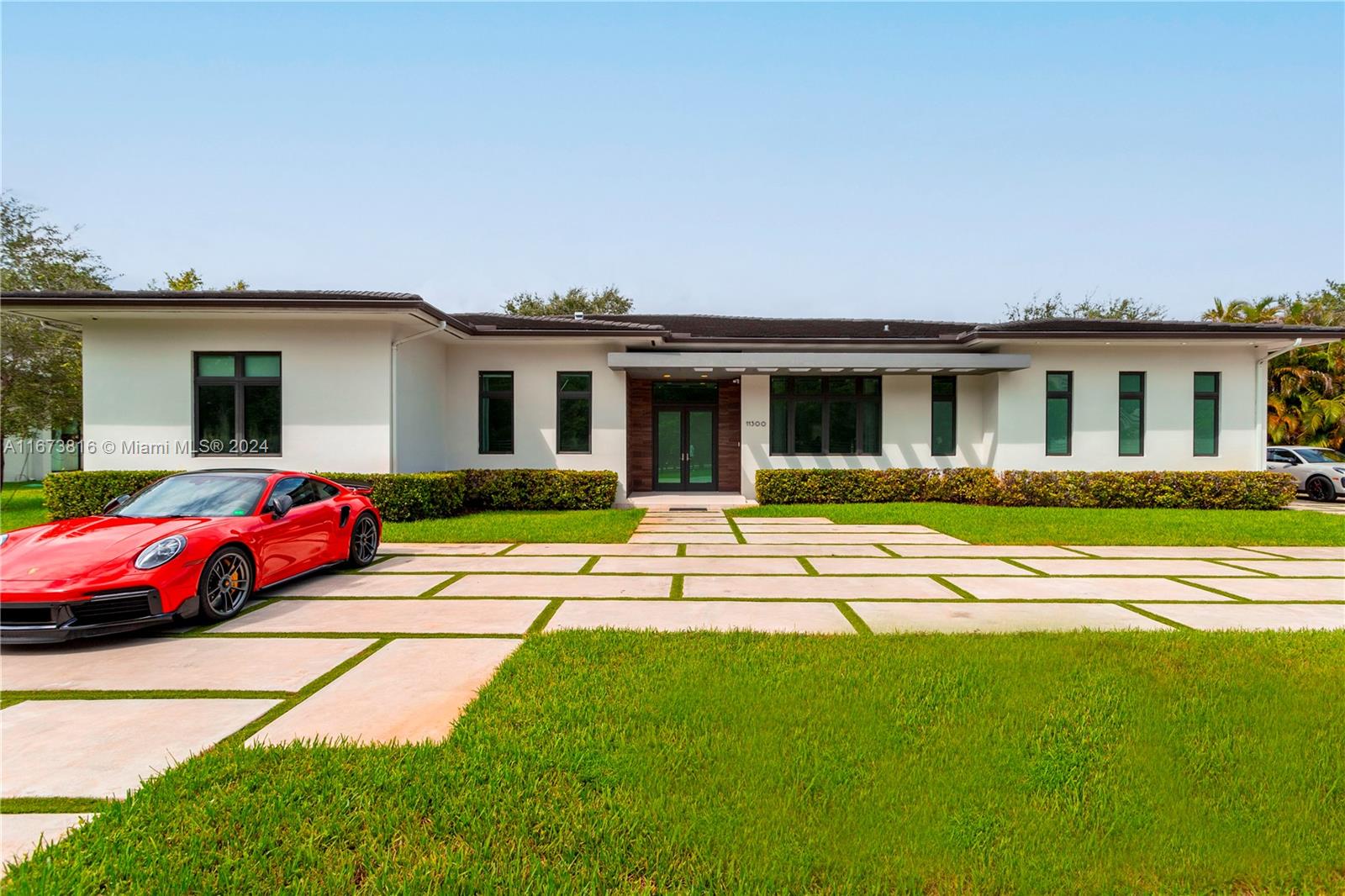 Exquisite contemporary one-story estate in Pinecrest, built in 2018! This modern home ftrs 5 en-suite bdrms & 6 baths on a gated 26,500 SF lot. A grand foyer leads to formal living & dining areas, seamlessly connecting to the gourmet kitchen & family room. Kitchen boasts Italian cabinetry, Wolf/Sub-Zero appliances, dual dishwashers, a heating drawer, & large walk-in pantry. Opulent primary suite includes a seating area, walk-in closet, makeup station, pool access, & spa-like bath w/ dual water closets, a tub, shower, & double vanity. Sliding doors open to a covered terrace, pool w/ lounging area, & a large backyard w/ turfed mini soccer field. Add'l ftrs: 2-car gar, built-in speakers, walking distance to Suniland Plaza, & close to expressways & top schools. It's not Miami, It's Pinecrest!