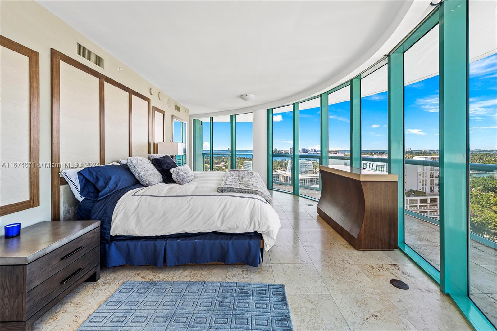 This luxurious 2,900 sq. ft. flow-through residence occupies the entire 19th floor, offering 360-degree views. The north-to-south facing layout with SE/SW exposure provides dynamic sunsets from the main living areas. Private elevators open directly into the home, with floor-to-ceiling windows flooding every room with natural light. It features 2 en-suite bedrooms, an office, a guest half bath, high-end finishes, marble floors, and a gourmet kitchen perfect for entertaining. The oversized master suite includes ample closet space and an infinity tub. Steps from the beach and close to shopping and dining, the condo offers 2 parking spaces, a pool, fitness center, and 24/7 security.