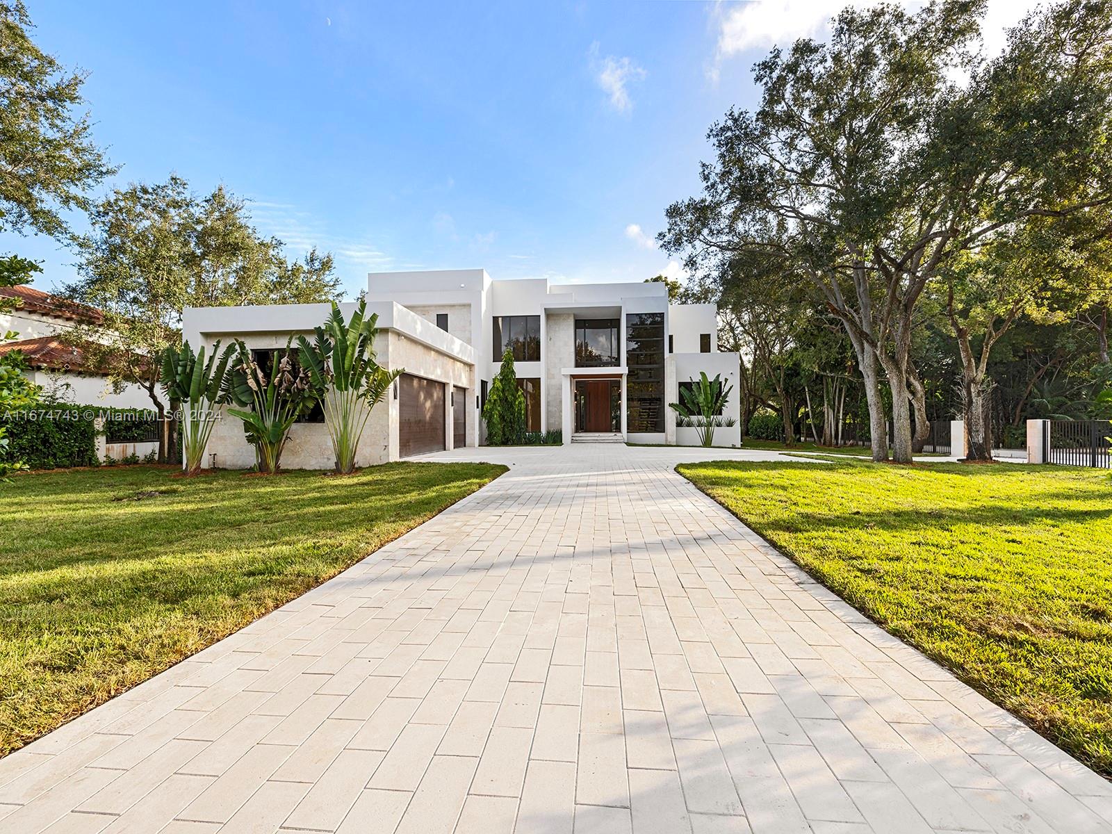 This brand new luxurious two-story corner residence features 7 bedrooms, 8 full bathrooms, and 2 powder rooms all within 8,805 Sq Ft on a nearly-acre lot. It includes a designated office, media room, and exercise room. Elegant touches throughout the home include an artisan floating staircase, handcrafted and hand pressed terrazzo slabs, and a double-sized master closet, adding a sophisticated flair to the design. The custom kitchen features custom white oak cabinets and high-end SubZero and Wolf appliances. With dual laundry rooms on both levels, service living quarters, and a separate guest house, privacy and comfort are assured. The outdoor space boasts an oversized heated saltwater pool with a spa and a summer kitchen, perfect for entertaining.