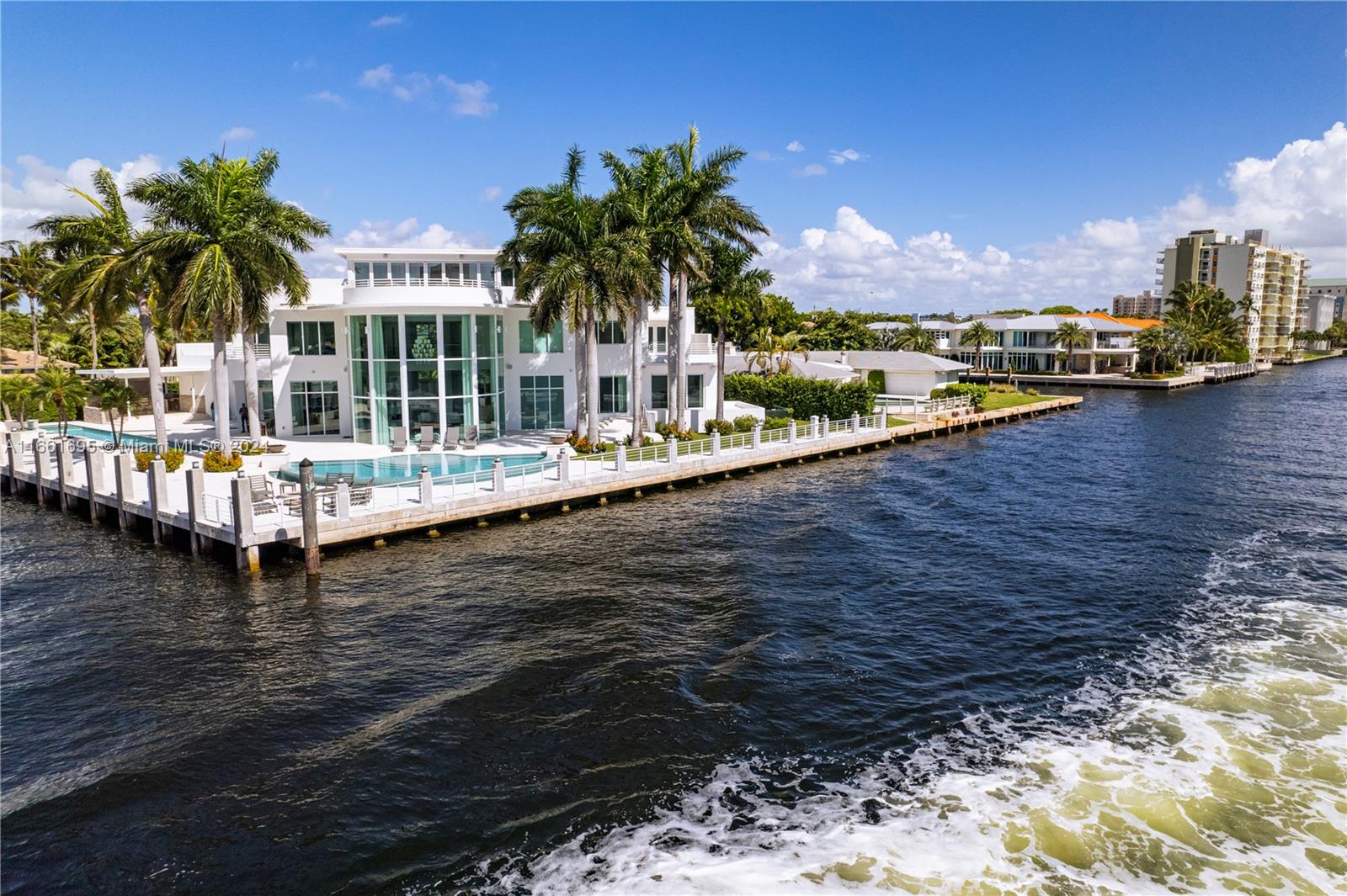 WATCH THE VIRTUAL TOUR. Modern masterpiece with bespoke details offers sprawling luxury living and boating! Situated on prestigious Intracoastal Waterway in Ft Lauderdale, Point lot, this home boasts extraordinary views. Fully furnished (2022 furniture), open floor plan with ample natural light with easy access to outdoors. This private residence with unmatched indoor/outdoor living spaces features a sensational roof top terrace, balconies, 2 heated saltwater swimming pool + spa, covered summer kitchen with BBQ, 240' of waterfront, + 6 car garage with 3 lifts. Dock over 120"feet, Standby generator. All impact windows and doors. Huge glass wine cellar.