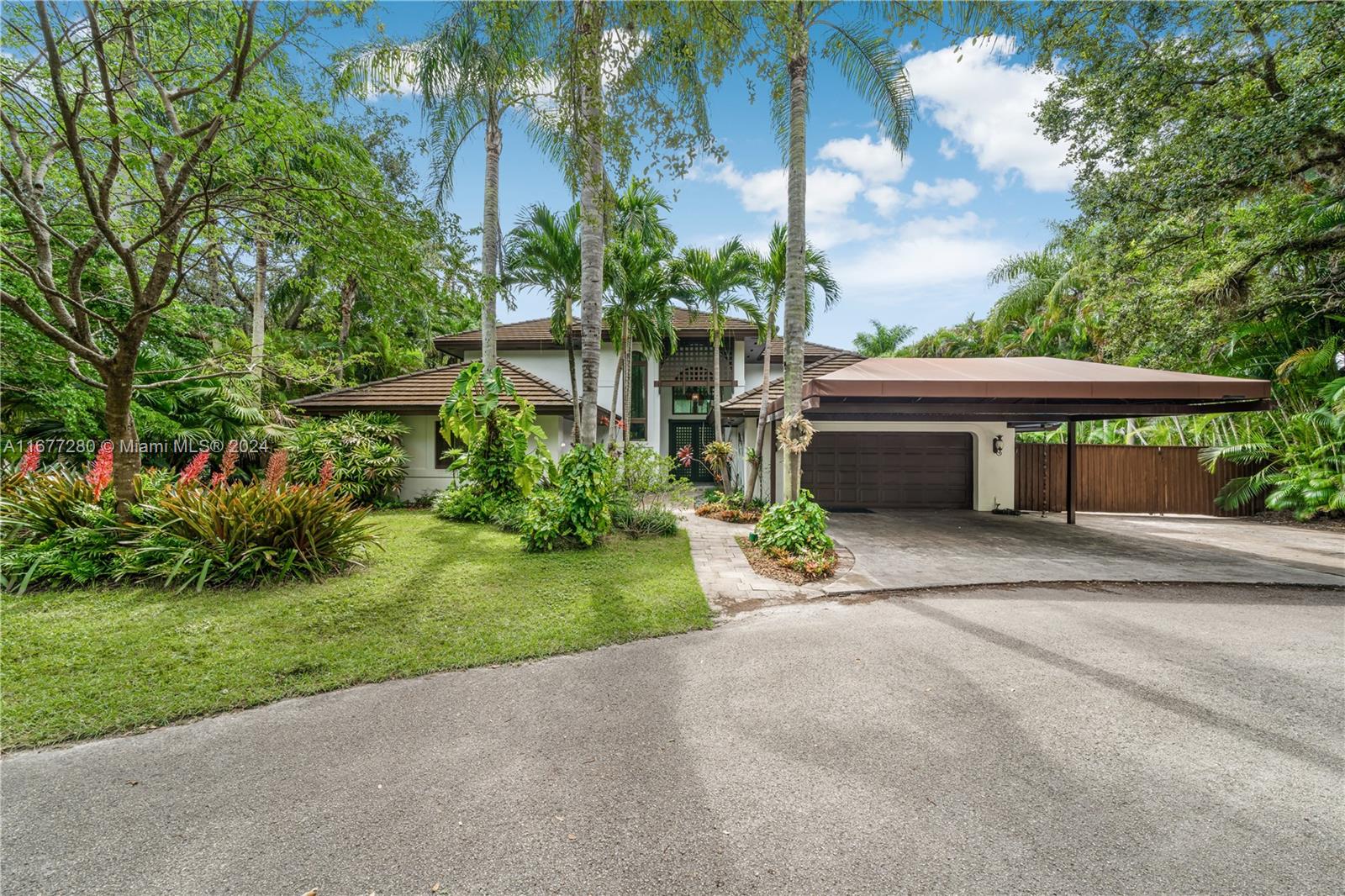 Experience the perfect blend of luxury & tranquility! Stunning Hollub home nestled in quiet, no-traffic cul-de-sac in N Pinecrest. Perfect floor plan, over 5,086 SF under roof  
w/4BR 3.5BA + 2 car gar. Spacious master suite, lavish bath, steam shower & Jacuzzi tub + Media/Family Rm + Guest Rm w/ensuite bath on 1st floor & powder room. Upstairs, 2 large bdrms w/ Jack & Jill bath for family/guests. Lots of natural light + 18’ ceilings in the expansive open living spaces; gourmet island kitchen, Thermador gas range, granite & SS appliances. Impact doors/windows seamlessly connect indoor outdoor living with large porches, summer kitchen, heated/cooled lagoon pool & integrated hot tub. Elegant limestone & wood floors, fireplace, relaxed HOA. An exceptional opportunity you won’t want to miss!