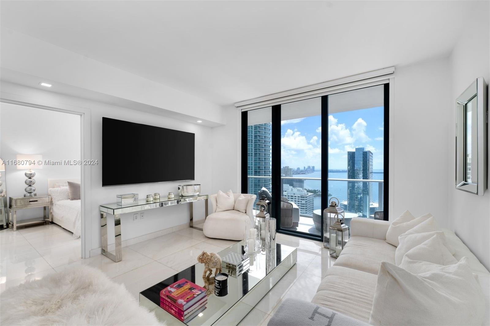 This stunning 2 Bed/3 Bath + Den apartment in Brickell is fully furnished and offers breathtaking views of the Bay. Designed with a "concept of all white elegance," it features luxurious marble flooring, custom closets, automatic blinds and an Italian-designed kitchen. The upgraded lighting includes electric dimmer switches, creating a bright and glamorous atmosphere. The unit comes with 2 parking spaces, access to unparalleled amenities, including a rooftop pool, indoor pool, outdoor theater, a state-of-the-art fitness center with Peloton bikes, a spa with a steam room, sauna, jacuzzi, and cold plunge, along with a massage room, playroom, arcade room, squash court, basketball court, and exercise trail. Just steps away from the best restaurants & a few blocks from Brickell City Center.