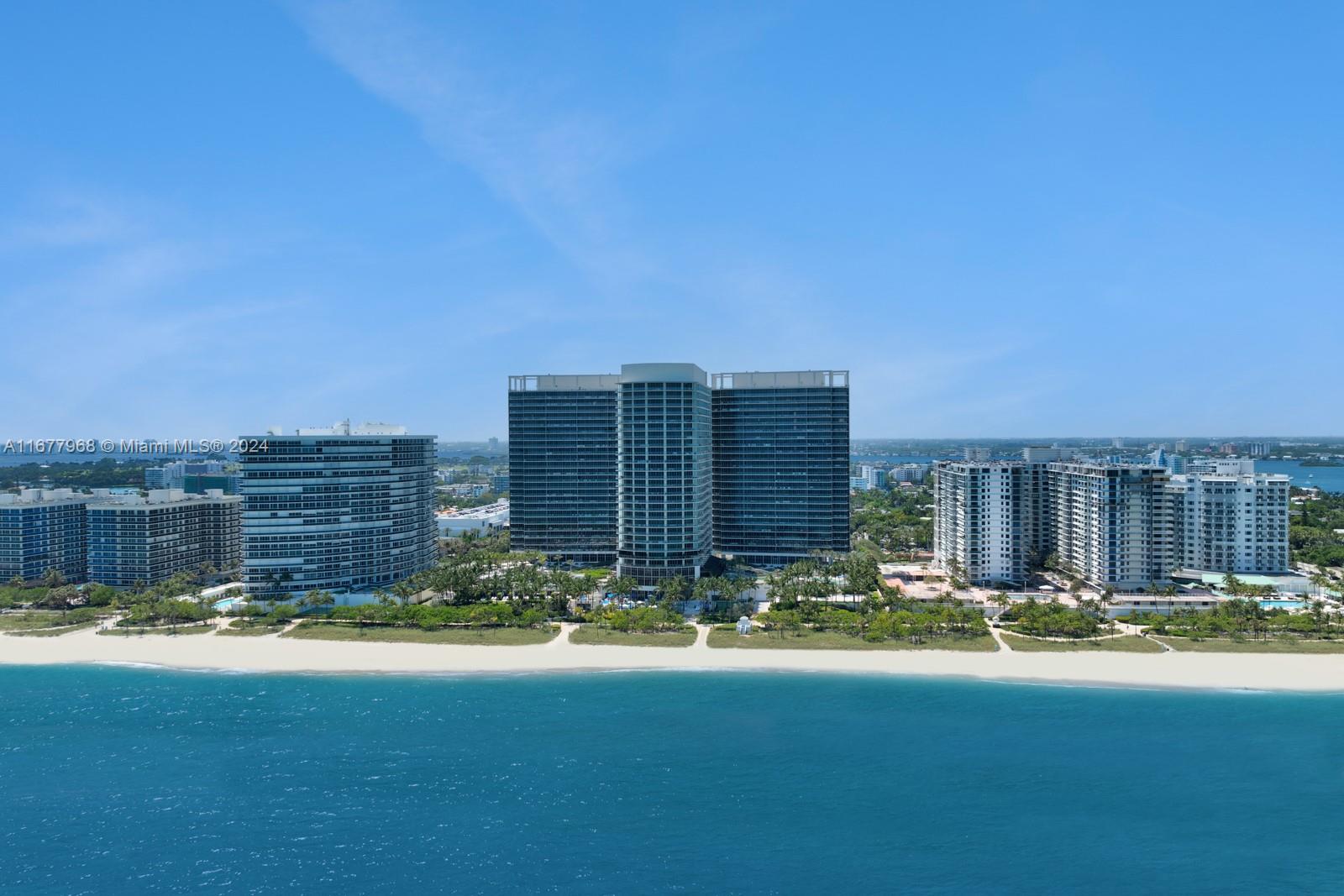 Welcome to Residence 501N, an exceptional corner flow-through unit in the prestigious St. Regis Bal Harbour, one of Miami's most coveted oceanfront addresses. This rarely available, turnkey-furnished home spans over 3,500 SF w/bespoke interiors by Steven G Interiors. With 3 bedrooms + den (4th bedroom) & 3.5 bathrooms in a split floor plan, this spacious sanctuary boasts stunning design & luxurious features. The chef's kitchen features Wolf, SubZero, & Miele appliances. The lavish primary suite offers a massive walk-in closet, wet bar, private sunrise terrace, & spa-like bathroom w/rainfall shower, dual sinks, & water closet w/bidet. Additional bedrooms are ensuite & generously sized. World-class amenities include 24-hour concierge, private beach service, pool, spa, fitness center, & more!