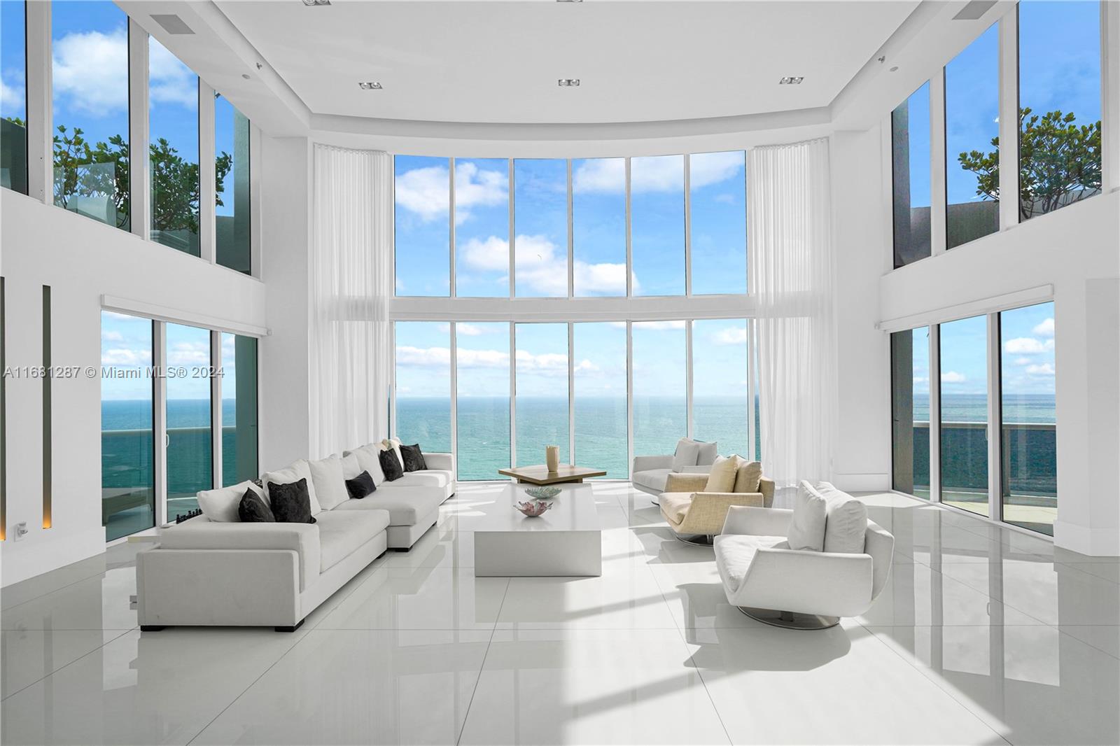 This one-of-a-kind PENTHOUSE boasts 180-degree OCEAN VIEWS and private elevator entry, making it the ultimate beachfront retreat with the most expansive floorplan available. Spanning 5,901 SF across two stories, this remodeled residence features 6 bedrooms, 6.5 bathrooms, and 4 balconies with views to the north and south. The bright interiors showcase porcelain floors throughout and floor-to-ceiling windows. Equipped with a Crestron smart home system, the modern kitchen offers ocean views and top-of-the-line Miele appliances, including a double electric oven, stove, Sub-Zero fridge, and granite countertops. The building offers full-service luxury amenities, including a resort-style rooftop, hot tub, gym, coffee bar, private beach service, tennis court, security, and more!