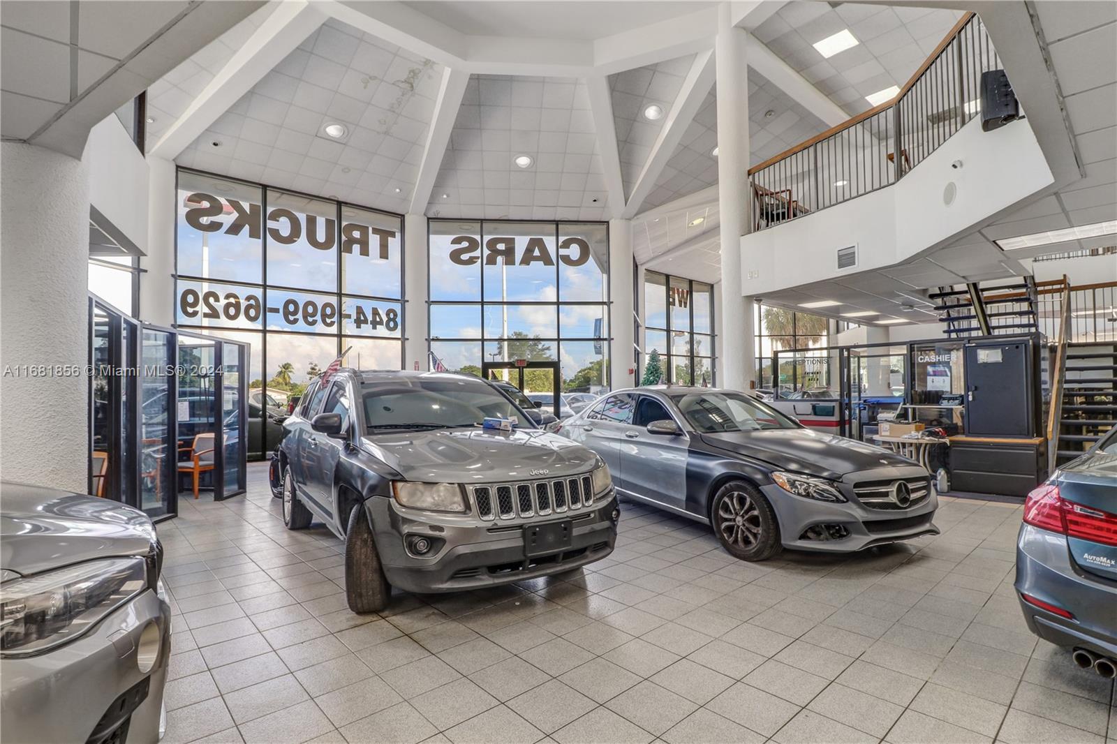 This iconic, 2-story, 41,000 SF dealership, under AC with parking for over 250 vehicles, is designed to accommodate every aspect of an automotive business with impressive functionality. The first floor features a showroom with ample room for vehicle displays, conference room, and financing center for smooth transactions. The building also boasts numerous private offices providing essential space for administration, sales teams, and management to operate efficiently. The property includes a state-of-the-art service center with vehicle lifts and service bays, capable of handling from routine maintenance to more complex repairs. This prime location represents an unmatched opportunity to operate a thriving automotive business in one of South Florida’s most coveted automotive corridors.