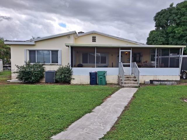 Very Nice Home located at peaceful countryside of South Dade County, this single-family home features 3 bedrooms and 3 bath, big terrace with updated bathrooms, kitchen, wood and tile floors, also has a horse stable, separate rear storage and additional quest quarters. Property also features additional lot Square footage of 11, 325 sqft. attached at rear of property totaling 92782 lot sqft.  This is a must see property!