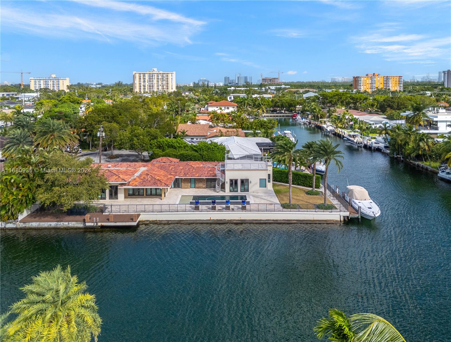 Discover the charm of Keystone Point. With over 180+ feet of frontage and no fixed bridges to the open water, this Single-story home is a boater's paradise. Situated on a sprawling corner lot, the property has a peaceful feeling as there is tropical landscaping, an oversized dock, and a stunning pool. This waterfront home offers four bedrooms, 4 1/2 baths, and a spacious 2-car garage, perfectly positioned just 10 minutes from the beach!  The open floor plan fills the oversized living area and kitchen with natural light. French doors create a seamless connection to the outdoors. Whether you're looking to relax or customize your space, this home offers endless possibilities for a true Florida lifestyle retreat.  This home will not last long. Please call the Listing Agent for showings.