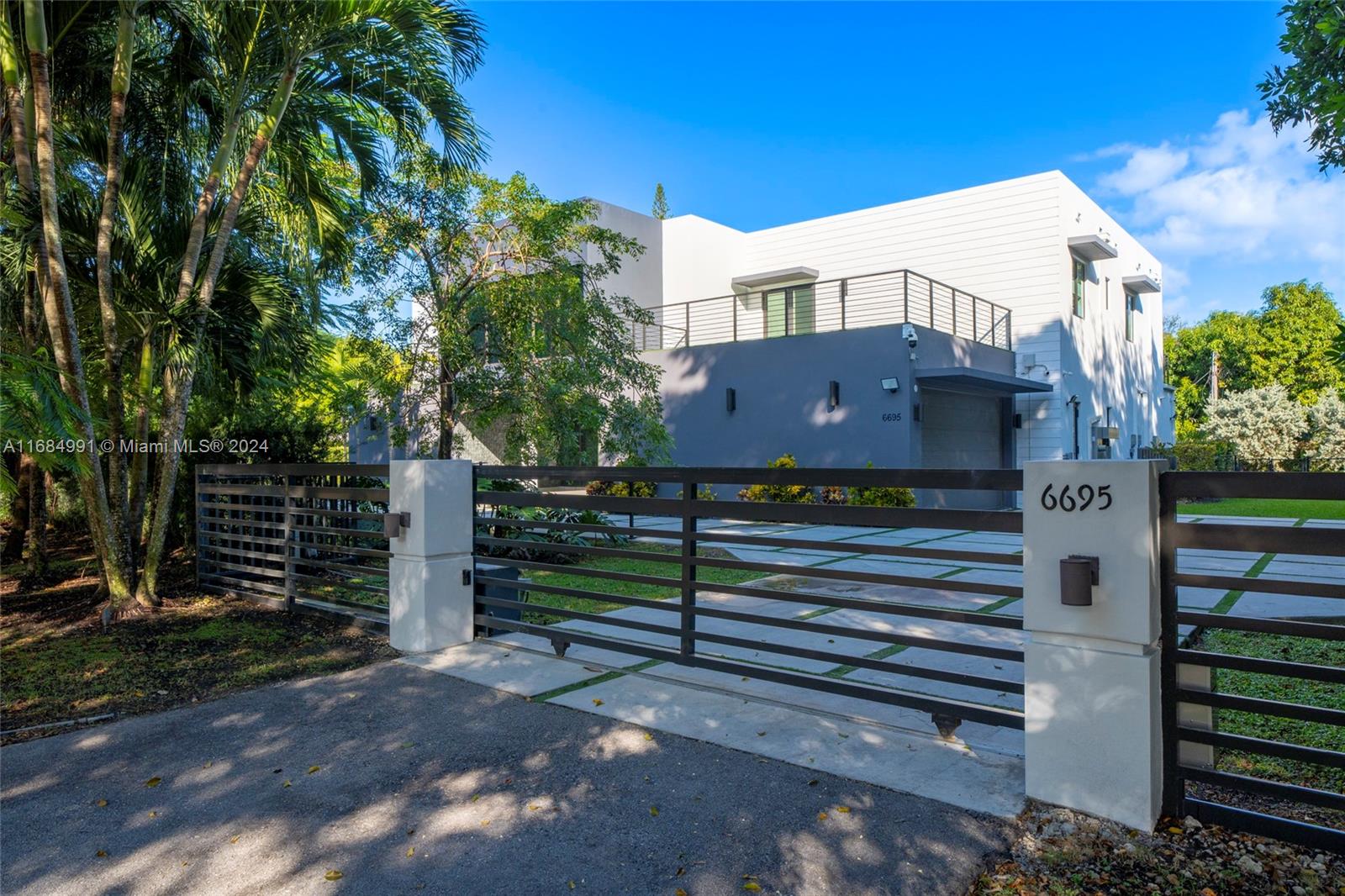 Presenting a stunning, modern masterpiece by ECO Modern Custom Homes. This exquisite 2-story residence is nestled in a welcoming Pinecrest neighborhood. Step through a solid wood pivot door into a spacious, light-filled living area with soaring 20-foot ceilings and premium Castellon porcelain flooring from Spain. With careful attention to detail, this 8,337 total s/f home offers 7 bedrooms, 7.5 baths, dual car garages, a media room, wine cellar, Pedini kitchen, safe room, and office. Set on an expansive 30,094 s/f lot, the outdoor space is perfect for entertaining, featuring a pool and lush landscaping around the property. A fully equipped smart home, it provides convenient control through a smartphone app.