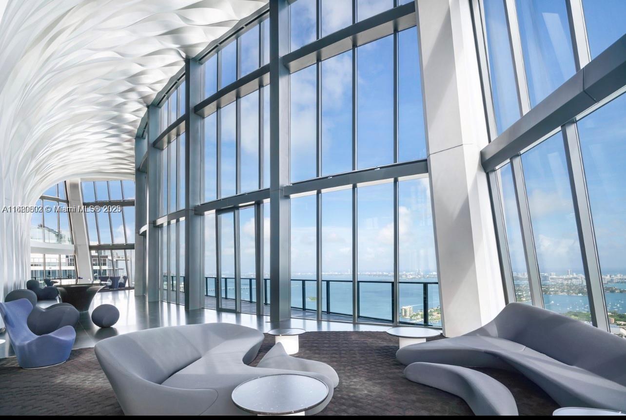 Discover the epitome of luxury living at Residence 2402, a 4,600 Sq.Ft masterpiece by Zaha Hadid at One Thousand Museum. Marvel at panoramic views from this half-floor residence with soaring 12 ft ceilings—the only unit offering such unparalleled height. Live in Miami's finest location, near Kaseya, Perez Museum, and the Frost Science Museum. The SE exposure bathes the residence in natural light, offering open Biscayne Bay views from the primary suite and great room, along with captivating sunsets over Miami. Pristine finishes include a Poliform kitchen, Gaggenau & SubZero apps, Apure Lighting by Petzold, and Crestron Home Automation. This exclusive residence boasts the only half floor with privacy and unobstructed views.