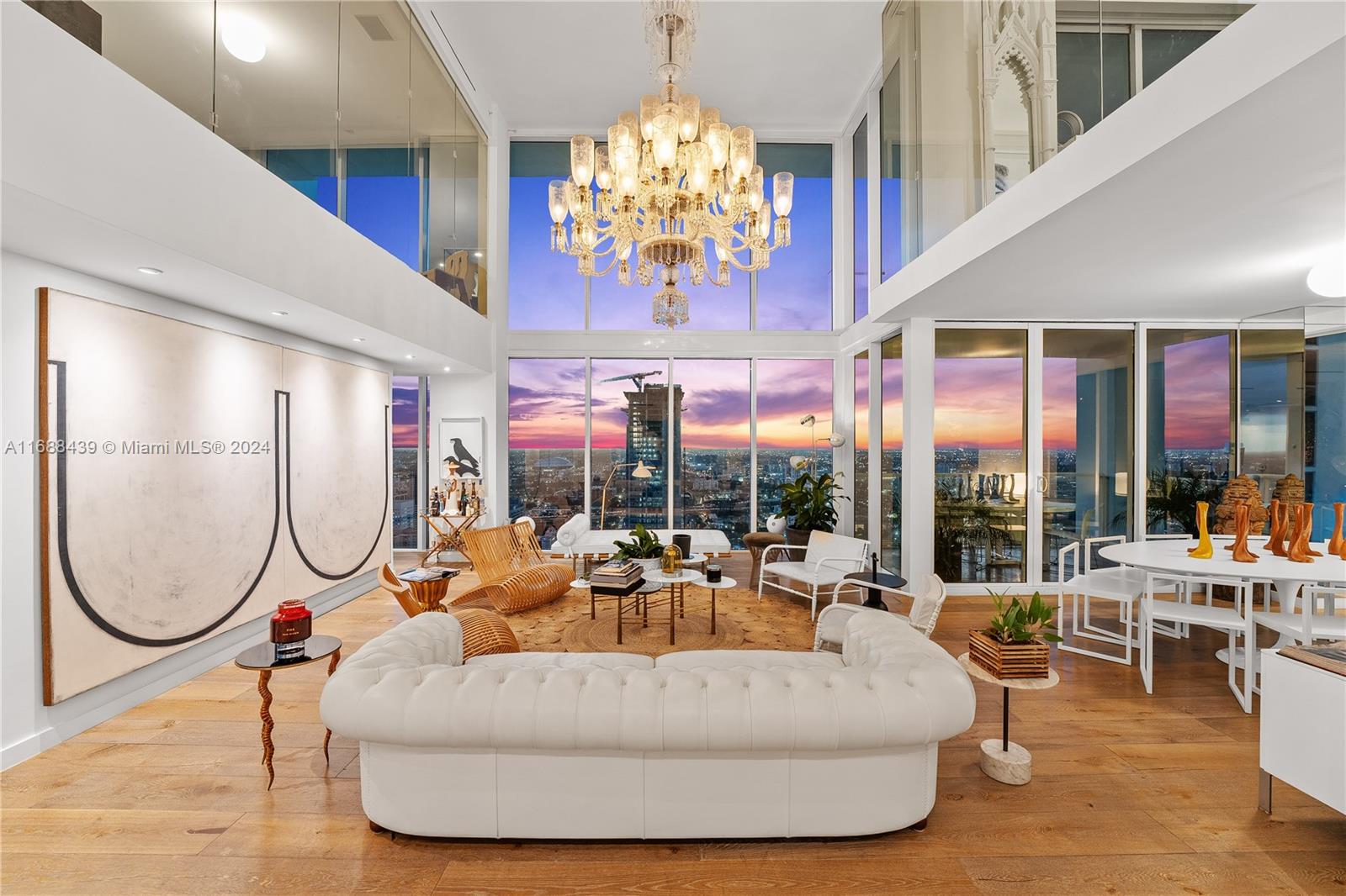 EXPERIENCE UNMATCHED ELEGANCE IN THIS ONE-OF-A-KIND 3-STORY PENTHOUSE LOFT WITH PRIVATE ROOFTOP POOL DECK BOASTING PANORAMIC SUNSET VIEWS IN THE HEART OF THE MUSEUM DISTRICT OF MIAMI! Featured in Architectural Digest & Curated by fashion designer Naeem Khan, this 2,560 SF 2-Bed (Convertible to 3) 3.5-Bath residence boasts 22FT ceilings & floor-to-ceiling windows, & a Lofty Living Area w/Sleek White Finishes. Poliform Kitchen features Bookmatched Taj Mahal Stone countertops. Miele Gaggenau, & Sub-Zero SS appliances. Floating Staircase leads to Mezzanine w/luxurious primary suite, Guest suite & Custom Bookcase-Wrapped Family Room. Rooftop level indoor summer kitchen, sauna & terrace w/huge pool. Automated Somfy Shades, Oak floors. 2 Parking Spaces. Includes membership to Bentley Beach Club.