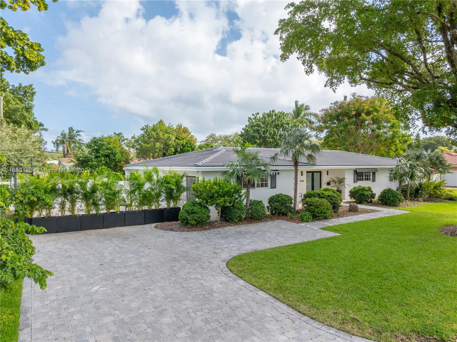 Step into this unique 4-bedroom, 3-bathroom home in prestigious Palmetto Island, fully renovated home with exceptional quality and finishes throughout. The home offers a welcoming common area, perfect for enjoying family time together. Homes with a spacious covered terrace like this are rare to find, creating an additional ambiance that expands the living area. The split floor plan includes a renovated master bedroom with a walk-in closet, full bathroom with 2 sinks, and private patio access. Across the home, there’s a bedroom with en-suite and two additional bedrooms sharing a full bath. The spacious kitchen features a bar that connects the living, dining, and kitchen areas. Covered terrace with entertaining spaces, summer kitchen, BBQ, sink, and fridge. Impact windows and brand-new roof.