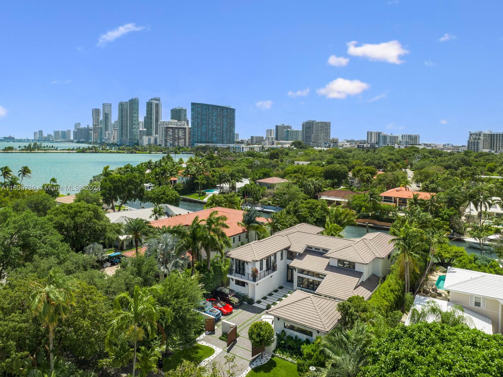 CASA EXUMAS – A Boater's Dream and a true Miami lifestyle experience. Nestled in the exclusive, gated community of Bay Point, this luxurious, modern tropical waterfront residence offers approx. 85 feet of water frontage with a private dock and direct access to Biscayne Bay. Enjoy high-end finishes, including spacious living room with 25-foot ceilings, sleek fireplace, formal dining room with wine cellar, family room, & gourmet kitchen. Six generous bedrooms feature private bathrooms and walk-in closets, including office and maid's quarters. Exteriors include a double-height, air-conditioned 3-car garage with car lift, 5-car motor court, infinity-edge pool, jacuzzi, summer kitchen, Ipe wood deck surrounded by tropical landscaping. Smart home system & generator. Private financing available.