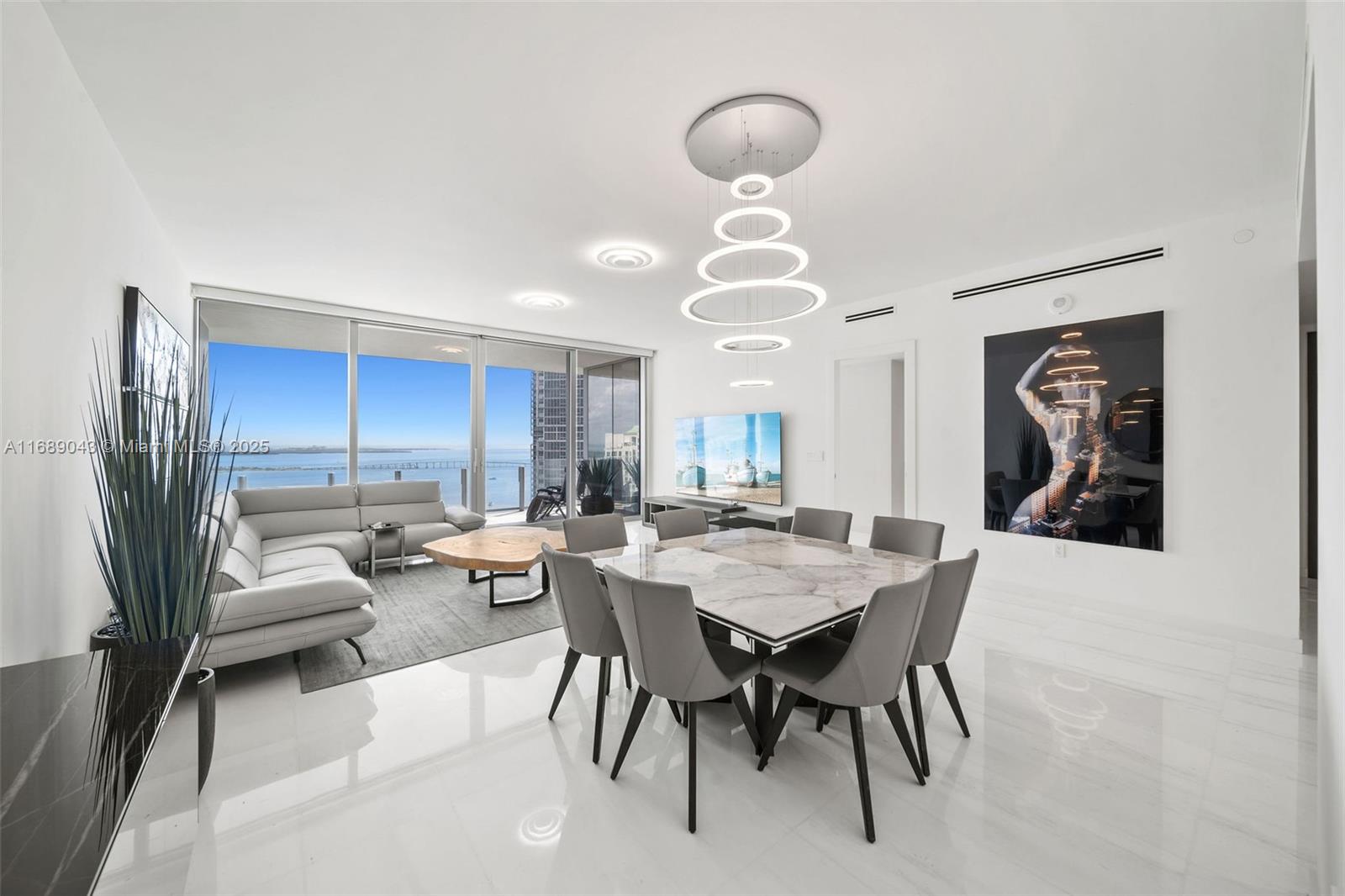 Experience luxury living in this brand-new unit at the prestigious Aston Martin Residences Miami. This exquisite 3-bedroom +Den+Family+Staff 4.5-bathroom residence defines sophistication and elegance. The design embodies the iconic style of the automotive brand, enhanced by stunning views of Biscayne Bay and Miami Beach from floor-to-ceiling windows and a spacious balcony. Enjoy the Sky Amenities level featuring 42,500 square feet of luxury amenities, including an infinity pool, spa, private movie theater, and state-of-the-art gym. Inside, the unit boasts exceptional craftsmanship, with a gourmet kitchen outfitted with Gaggenau appliances, marble floors, and expansive windows that fill the space with natural light. This exclusive address offers a refined lifestyle of luxury and convenience