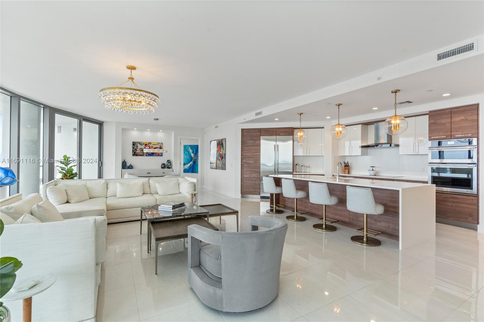 Stunning, furnished 42nd floor condo in 100 Las Olas. Enjoy luxury living in this 2,658 sq. ft residence. 3 Beds + Den & 3.5 Baths. Floor-to-ceiling windows, great natural light, large terraces; spectacular sunsets & river views. Professionally furnished w/designer custom furniture, lighting, marble floors, high-end finishes. Fully equipped gourmet kitchen: European cabinets, quartz counter tops, top of the line appliances. Wet bar & wine cooler. Primary suite features 2 walk-in closets, luxuriously appointed bathroom. 2nd & 3rd bedrooms have ensuite baths, walk-in closets. Laundry room w/ full size washer, dryer. 2 assigned parking spaces included. 5 star resort style amenities: 24/7 concierge front desk, rooftop pool, club room, fitness room, onsite restaurant, valet parking & more.