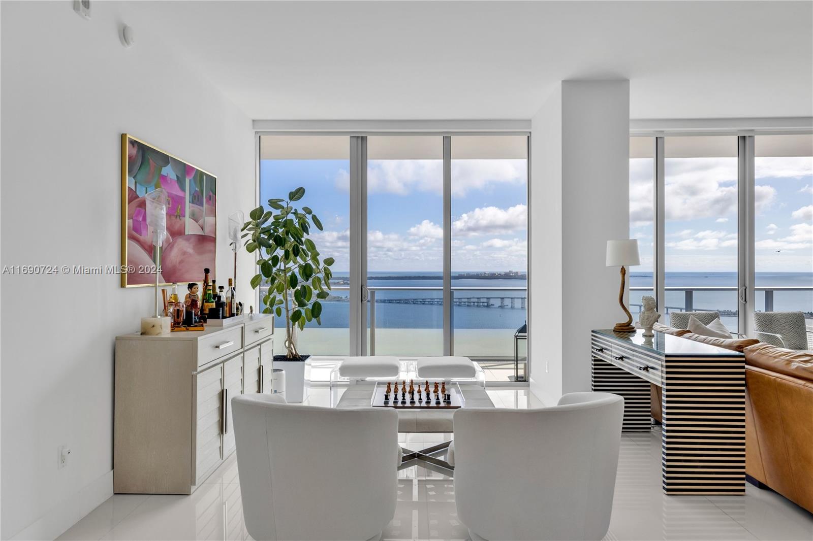 Experience luxury living in this stunning 2-bed, 3-bath residence in Brickell House, featuring 1,622 sq. ft. of contemporary elegance. Enjoy breathtaking sunrise views over Biscayne Bay from every room, through its floor-to-ceiling windows and access to its deep and easily accessible balcony. The unit boasts soaring 11ft ceilings, a spacious, open layout, and ample storage with walk-in closets. The eat-in open kitchen is equipped with high-end appliances and a spacious pantry, while a large laundry room adds extra convenience. Both bedrooms are spacious with the primary offering a stunning bathroom with soaking tub. Brickell House offers resort-style amenities, including two pools, one being a lap pool, BBQ area, fitness center, lounge, sauna, steam room, valet & automated parking garage.