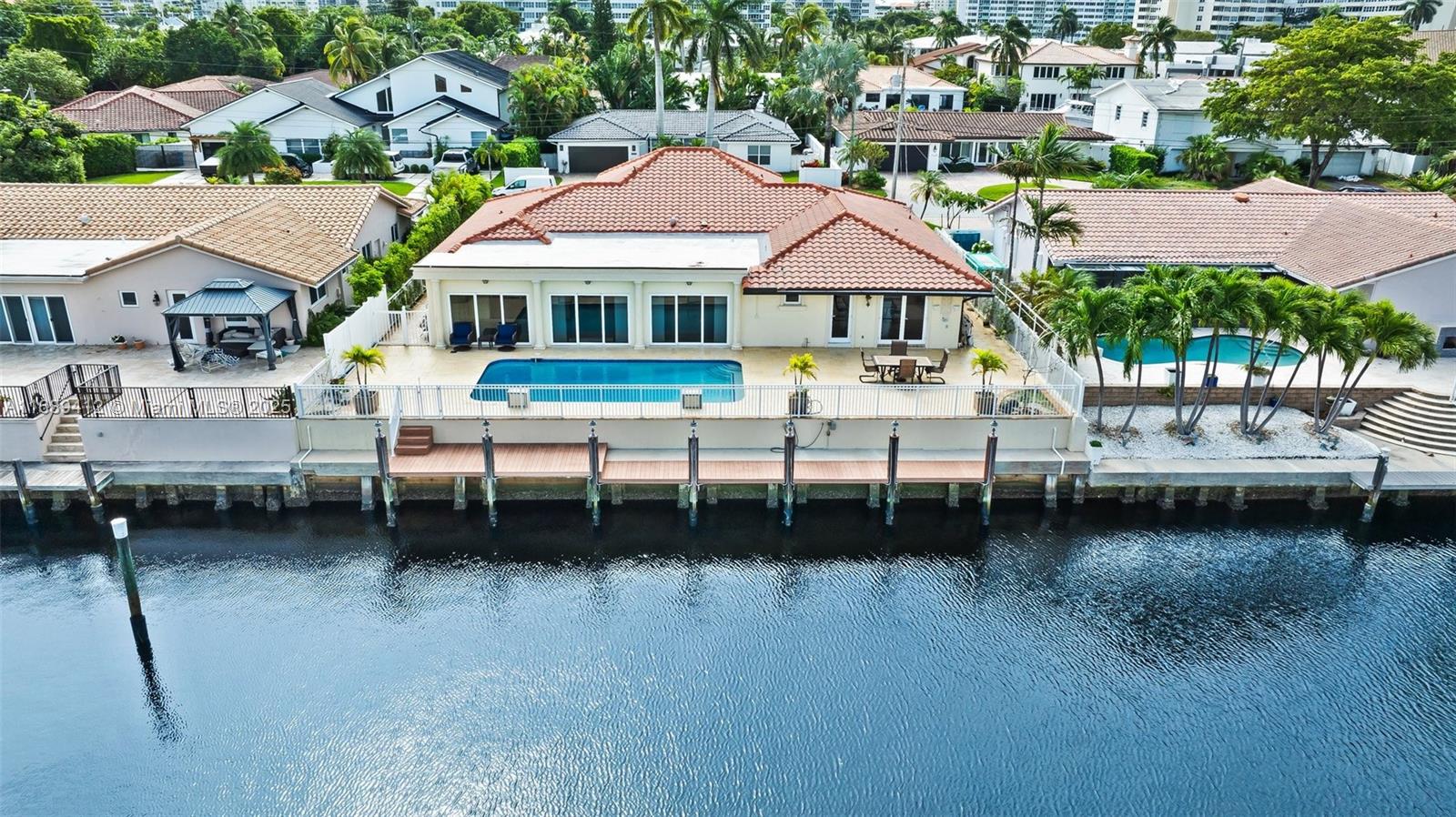 Exceptionally well maintained 4 bedroom residence with direct access to intracoastal waterways and no fixed bridges.  An excellent investment property, vacation home, or value add remodel.  Located in the gated community of Bermuda Riviera within Bayview School district.  An ideal place for boating enthusiasts to dock up to a 70 foot yacht.  Just minutes away from fine dining, shopping, and pristine beach access, this rare condition home provides privacy, luxury entertainment, and convenience.  Enjoy the best of South Florida living and lifestyle in this incredible community.