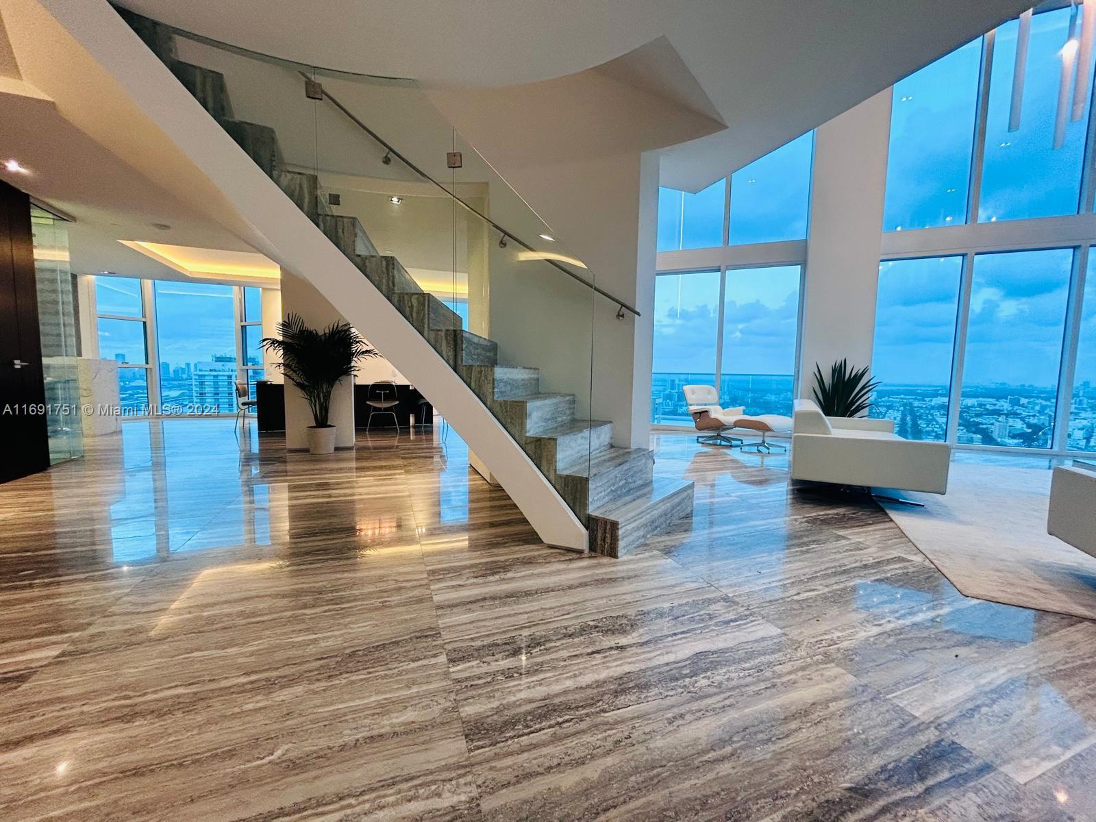 Completely Remodeled ( 4 units combined into 1 Big Penthouse )
 • Views: 360-degree views of Atlantic Ocean, Biscayne Bay, Miami skyline
 • Interior: Industrial/modern design with 18-ft ceilings, silver travertine floors, rare Mikasa wood, and Statuary Marble
 • Luxury Touches: Bank vault-inspired door, backlit Onyx wall, two grand stairways, chef’s kitchen
 • Amenities: Interior elevator, private sauna/steam room, 24-hour security, concierge, pool, spa, fitness studio



Parking 

 • 6 assigned parking spaces, EV charging, covered valet

Additional Details 

 • School Zones: South Pointe Elementary, Nautilus Middle, Miami Beach High