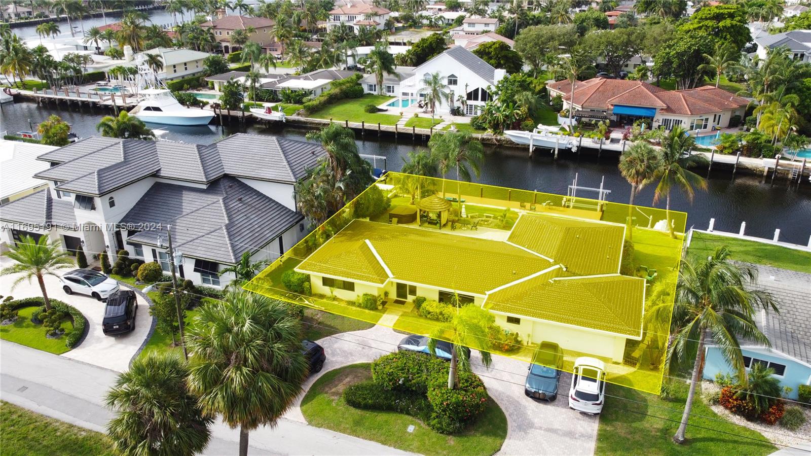 Welcome to this exceptional waterfront home in Pompano Beach, ideally situated in the sought-after Hillsboro Harbor area. New Roof, New Impact windows, New German Kitchen with Bosch Appliances, New Bathrooms, A/C Split Systems, New dock, New Garage Door, New Doors. In front of Park. No fixed bridges, 7 homes away from the Intracoastal Waterway. Boater's Paradise, close to the Hillsboro Inlet. Features 3 bedrooms and 3 bathrooms. South exposure, expansive pool and patio area, complete with a Sauna and a charming Tiki hut. 2-car garage, 105 feet of waterfront, a 13,000-pound boat lift, floating dock for JetSki. Natural gas hooked up, brick-paved circular driveway. Nestled on a serene cul-de-sac street, this residence offers a peaceful and picturesque setting.