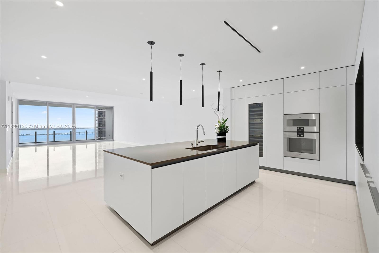 Experience luxury living in this brand-new unit at the prestigious Aston Martin Residences Miami. This exquisite 3-bedroom +Den+Staff 5.5-bathroom residence defines sophistication and elegance. The design embodies the iconic style of the automotive brand, enhanced by stunning views of Biscayne Bay and Miami Beach from floor-to-ceiling windows and a spacious balcony. Enjoy the Sky Amenities level featuring 42,500 square feet of luxury amenities, including an infinity pool, spa, private movie theater, and state-of-the-art gym. Inside, the unit boasts exceptional craftsmanship, with a gourmet kitchen outfitted with Gaggenau appliances, marble floors, and expansive windows that fill the space with natural light. This exclusive address offers a refined lifestyle of luxury and convenience