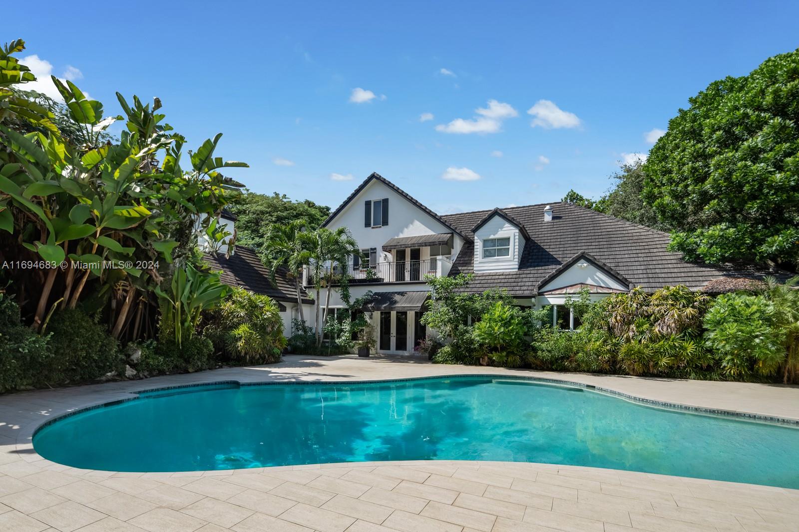 Exceptional 6-bedroom, 6.5-bath estate on a .98-acre lot in prime North Pinecrest. Renovated in 2016, the 7,923 sq ft home offers luxury and privacy with impact windows/doors, high ceilings, natural light, and a chef's kitchen with a walk-in pantry and second fridge. Featuring 8 rooms, including a gym and theater, it boasts a spacious primary suite with a walk-in closet and expansive bathroom. Extras include an elevator, ample storage, laundry room, and a generator. Outdoors, enjoy a heated saltwater pool, pergola, BBQ gazebo, and lush landscaping. Near top Pinecrest and Coral Gables schools, this home is one-of-a-kind.