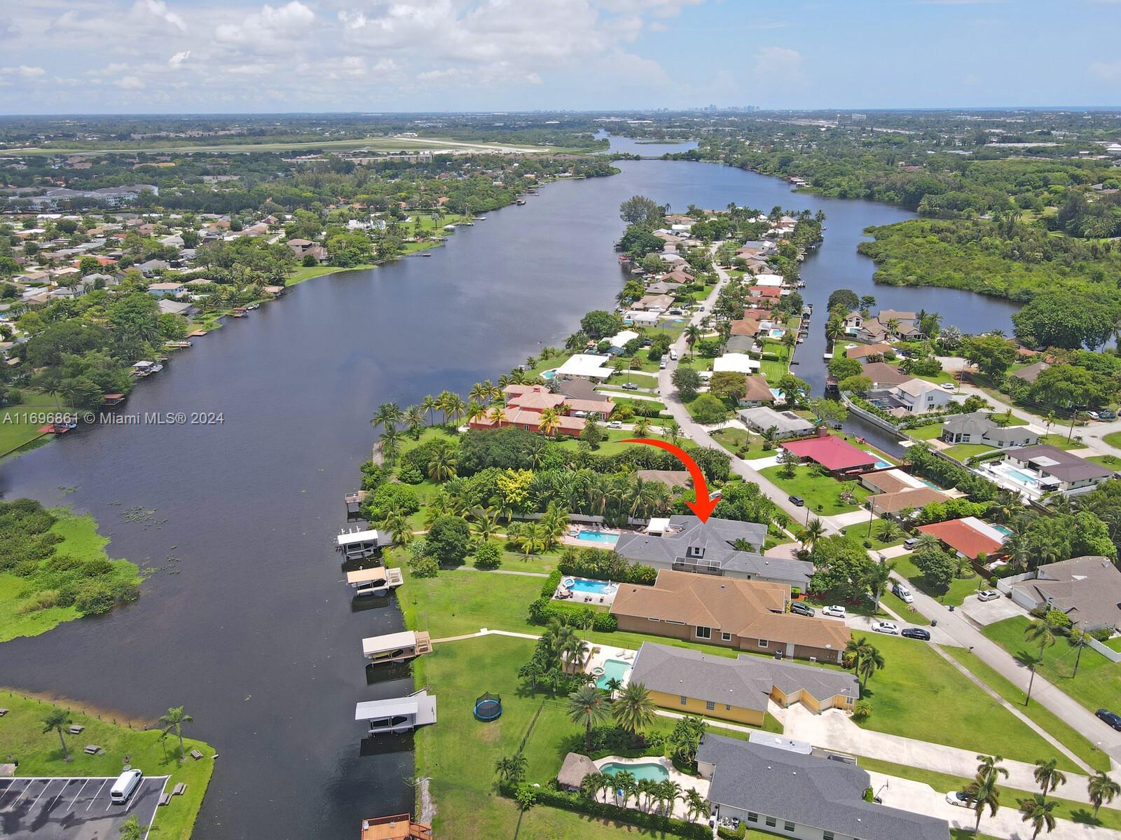 Jet Skis & all furnishings included with this stunning vacation home on Lake Osborne near Palm Beach and West Palm Beach Ideal for entertaining, short term rental. Private boat dock w/lift, 3 wave runner lifts, paddle boards, foosball, ping pong, gym, volleyball, game room, Sonos system, TV, and more. Fully stocked kitchen with quartzite counters & large island. Exquisite marble & cherry hardwood floors throughout. 2 dens, 1 may be used as a 6th bedroom. Upstairs private guest suite with balcony view of lake and sunsets. Close to airports, beaches, High Ridge Country Club, Manalapan, equestrian events, & entertainment unique to south Florida. Meticulously clean and maintained. Decorated with attention to details. Furnishings, linens, decor like new. No HOA. No rental restrictions.