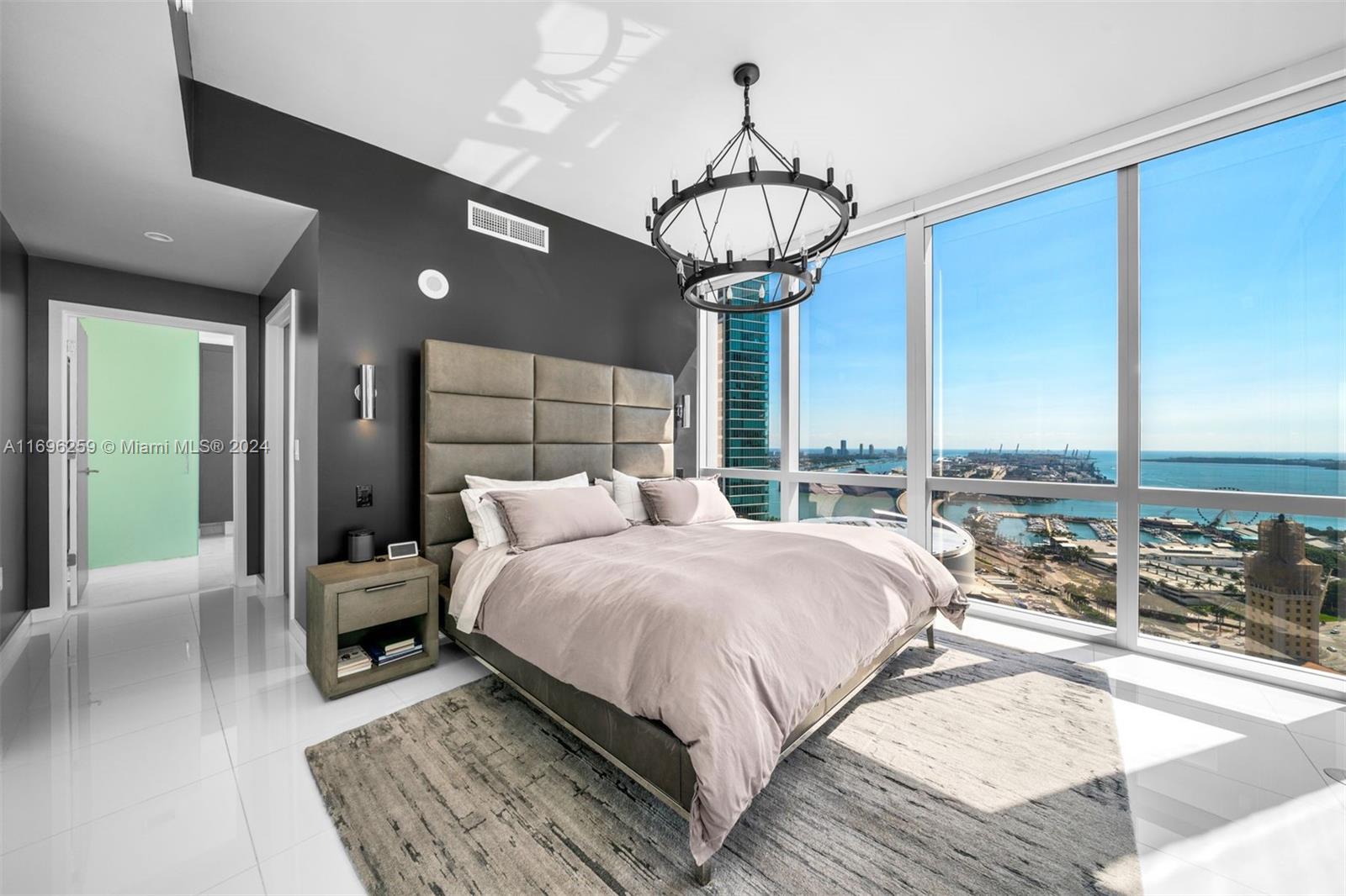 Immaculately designed 3 Bed + Den/4 Bath condo at the luxurious Paramount Miami Worldcenter featuring 2,188 int sq ft, 202 sq ft of terrace, private elevator foyer, laundry room w/ front-loading washer & dryer, 10-ft-high ceilings w/ floor-to-ceiling windows, and breathtaking views of the bay, city & ocean from 30th floor. Upgrades include motorized shades, Lutron smart dimmers, dropped ceiling in 2nd & 3rd Bedrooms & Den for overhead lighting, custom closet doors, and custom closet cabinets in all closets. Assigned storage cage included (seller purchased it separately). Direct water views from all 3 bedrooms, living room & terrace. 2 parking spaces included (1 assigned + 1 valet). Over 40 building amenities including 5 pools, 2 tennis courts, 2 hot tubs, gym, and more.