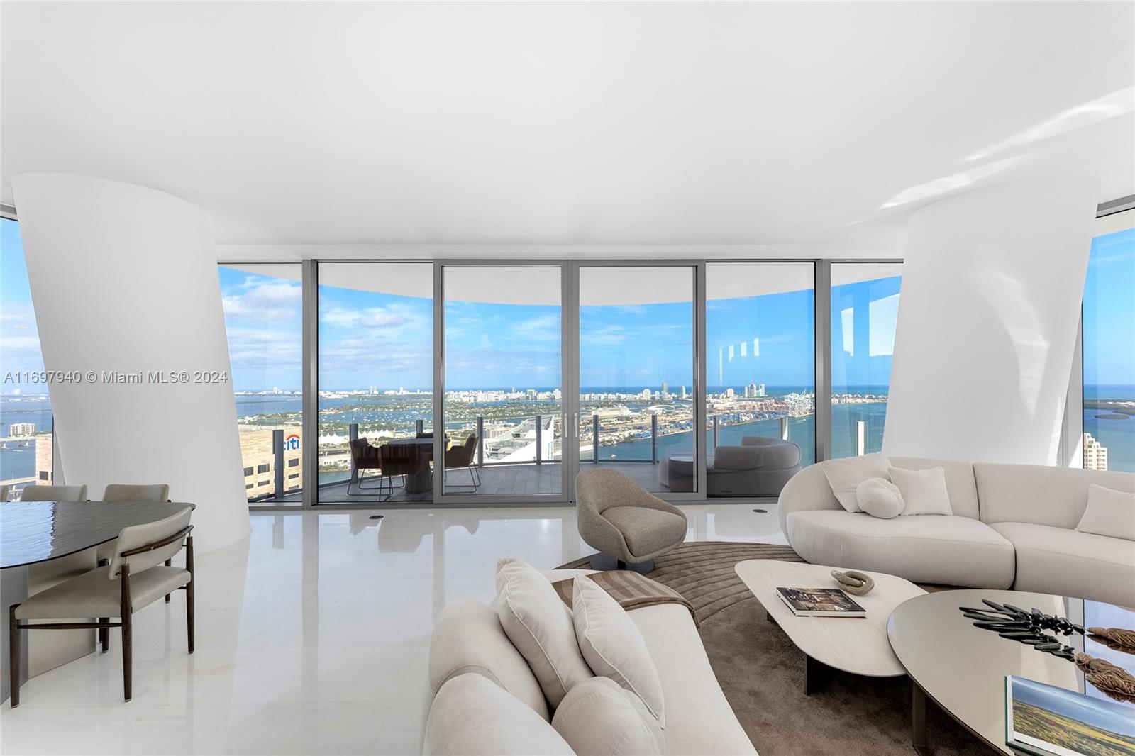 This stunning 4BR/5+1BA unit at the Aston Martin Residences in the heart of downtown Miami offers 3,731 SF of luxury w/exquisite Thassos marble floors throughout. A private foyer entry leads to a beautiful, redesigned living & formal dining area surrounded by walls of glass w/access to the wraparound terrace & uncompromising Ocean, bay, & city views. The new family room offers a private space to unwind, while the chef’s kitchen boasts top-of-the-line Gaggenau appliances, extended center island & a separate breakfast area. Sumptuous principal suite w/sitting area, a large custom walk-in closet & dual spa-inspired bathrooms w/marble rain shower, oval soaking tub & water views. 3 additional bedrooms each w/ensuite bathrooms. Sale of the unit includes an Aston Martin DBX SUV. 5-Star amenities.