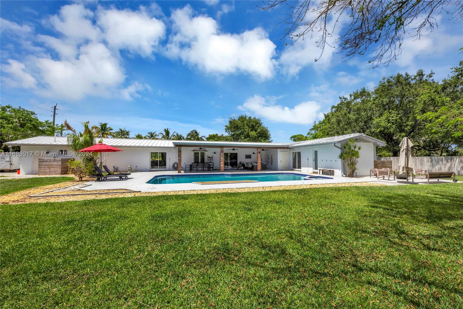 This beautiful 4 bedroom, 2.5 bathroom Palmetto Bay home spans 2,675 square feet on a sprawling 19,920 square foot lot.  Meticulously updated, it features a new kitchen with Bosch appliances, new hurricane impact glass throughout, newer aluminum roof, and fabulous newly renovated bathrooms!  The wonderful floorplan features a foyer entry, formal living and dining rooms, oversized family room with fireplace and built-ins, 4 bedrooms and 2 bathrooms to one side, with a large laundry/mud room, half bathroom, and 2 car garage to the other.  A deep patio spans the back of the home and makes for true outdoor living space overlooking the sparkling pool and spacious lot!