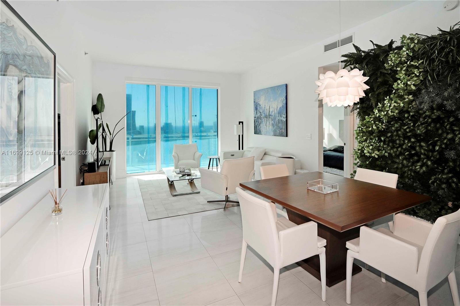 Fully Furnished 49th Floor 2/2 with spectacular views thru floor to ceiling windows and very tall ceilings in the Plaza on Brickell! Bright and vibrant 2bedroom split plan. Furnished with a custom Green Wall that adds an energetic accent to the unit, and electric blinds throughout. Situated in the very best area of Brickell, steps to Mary Brickell Village, Brickell City Center, Metro mover & the finest restaurants in Miami! This pet-friendly building includes STATE-OF-THE-ART fitness center, steam room, clubroom, children's room, business center, 10 guest movie theatre, 2 infinity Pools, Spa, and Jacuzzi & Valet Parking. Walking distance to Brickell City Center, Mary Brickell Villages, Shops, Banks, Restaurants, Pharmacy, and Publix. Just 15 minutes to Miami Int. Airport or Port of Miami.