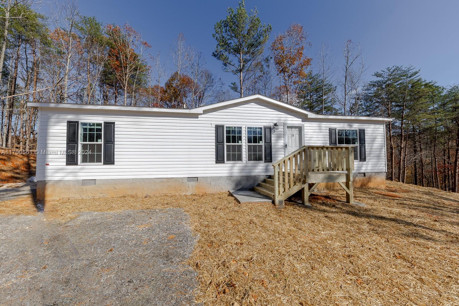 Nestled on a serene 1.5-acre lot in Jasper, GA, this charming 1,230 sq. ft. home is a perfect blend of comfort and style. Boasting white wood cabinets and stainless steel appliances, the kitchen is a dream for culinary enthusiasts.
The centerpiece of this space is the modern stainless steel farmhouse sink, offering both functionality and elegance. 
Relax in the luxurious master bath featuring a tiled shower and garden tub, while the second bathroom provides a versatile 60-inch fiberglass shower-tub combo. Enjoy cozy evenings by the electric fireplace set in a sleek gray entertainment center. This home also includes overhead vents for efficient airflow and a reliable Carrier heat pump for year-round comfort.  Don't miss this opportunity to own a beautiful home in a tranquil setting.