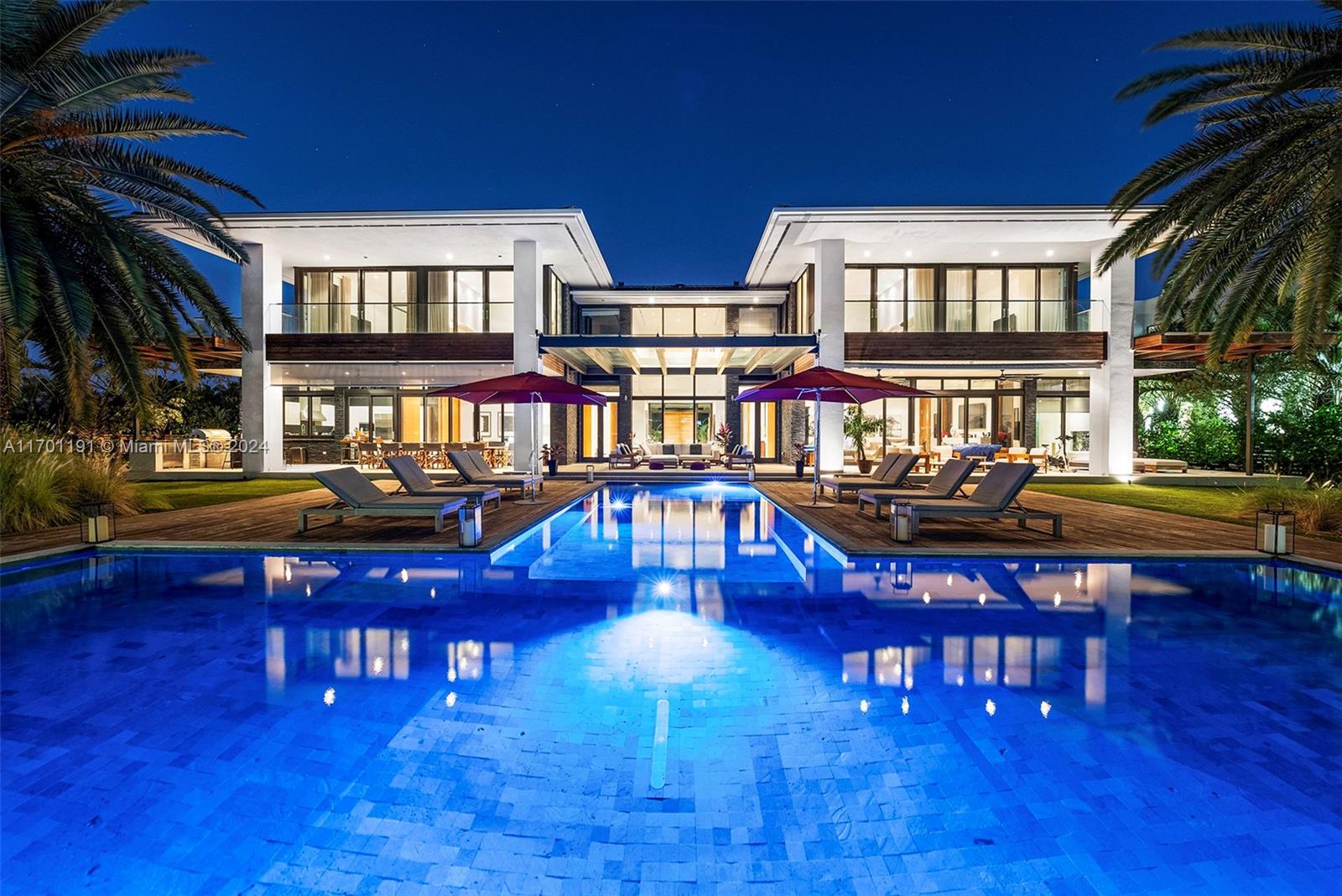 Welcome to 385 Center Island, a breathtaking tropical modern masterpiece in the exclusive enclave of Golden Beach. This legacy estate spans 22,688 sq ft, featuring a 14,225 sq ft mansion with 137 ft of direct Intracoastal frontage—perfect for yachting enthusiasts. Designed for both luxury and entertainment, the home offers 12 bedrooms, 12 bathrooms, expansive living spaces, a chef’s kitchen, and a formal dining room overlooking the stunning back deck.
This private oasis includes a double-gated driveway, parking for 8, an indoor gym and spa, and meticulous attention to detail throughout. Just steps from the neighborhood’s private beach, parks, and patrolled by its own police force, this is a once-in-a-lifetime opportunity to own Golden Beach’s crown jewel.